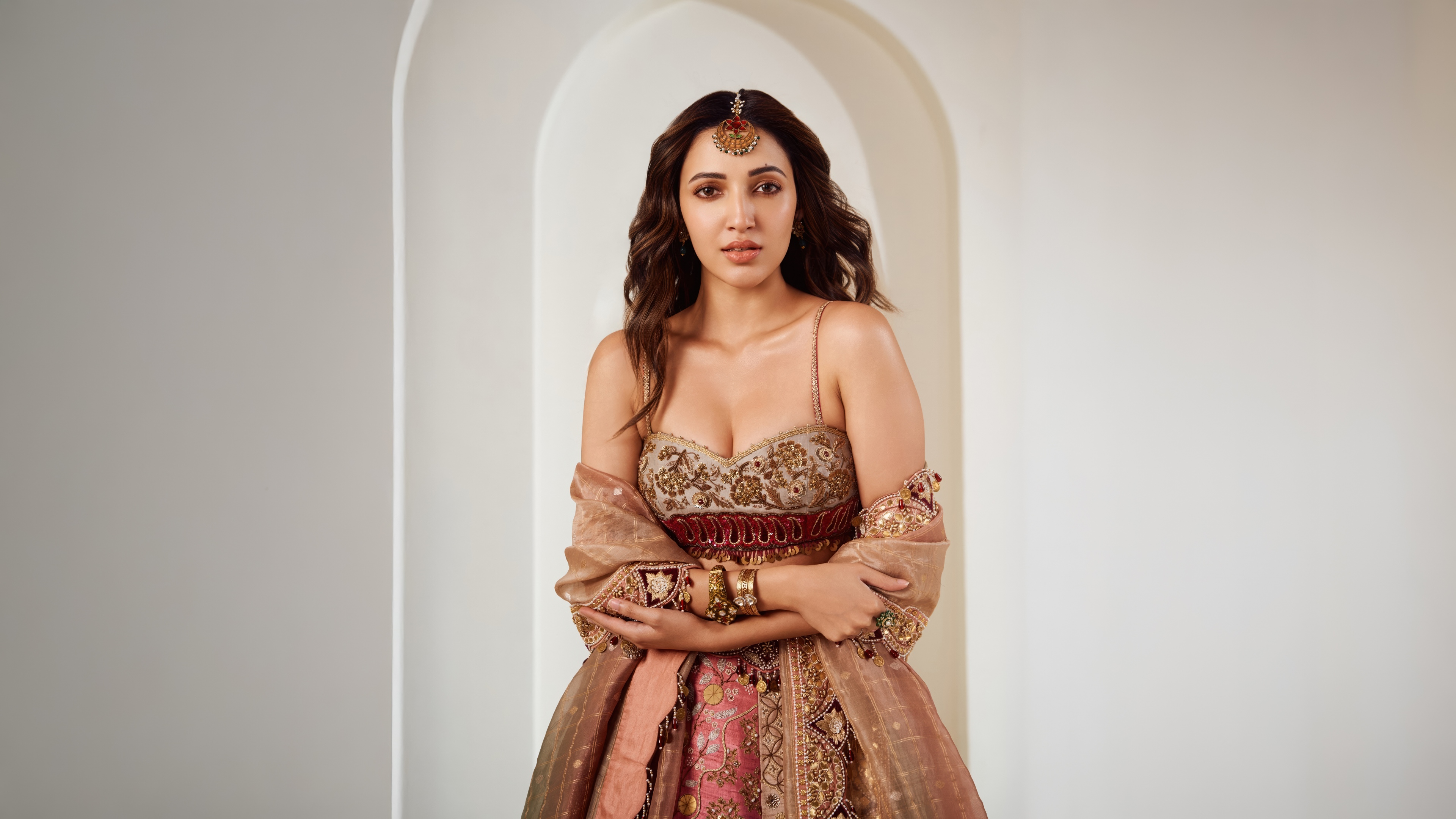Neha Shetty wearing a highly detailed and decorative traditional Indian lehenga.