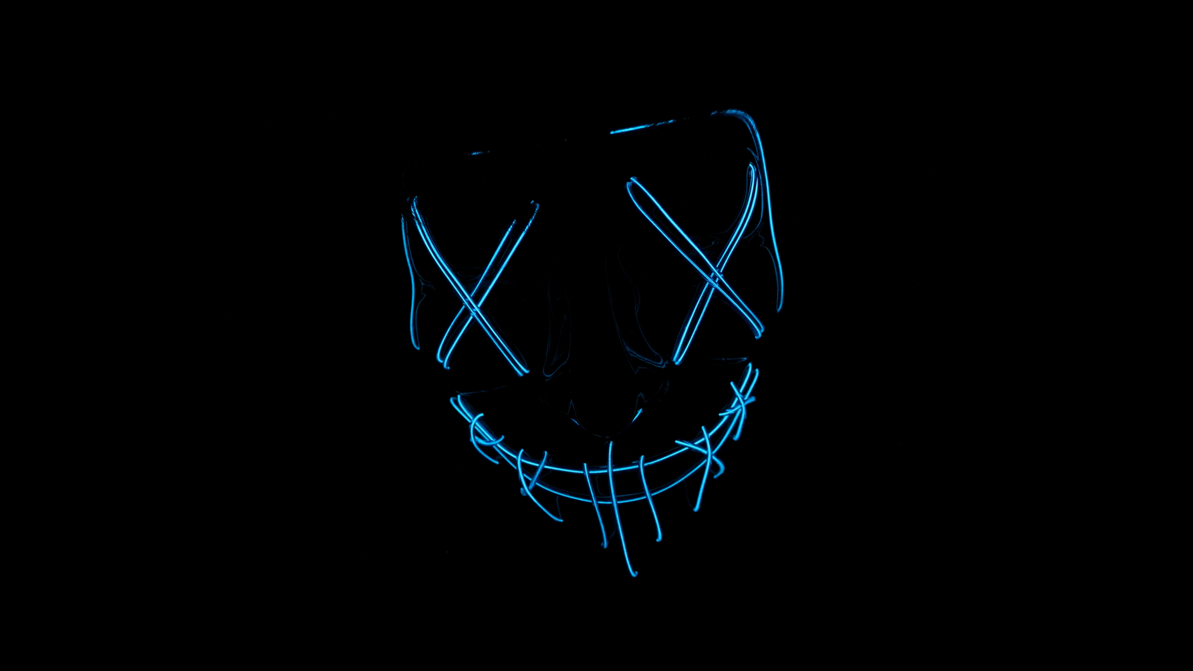 A glowing LED face mask with neon lights on a dark black background, inspired by the horror aesthetic of The Purge.