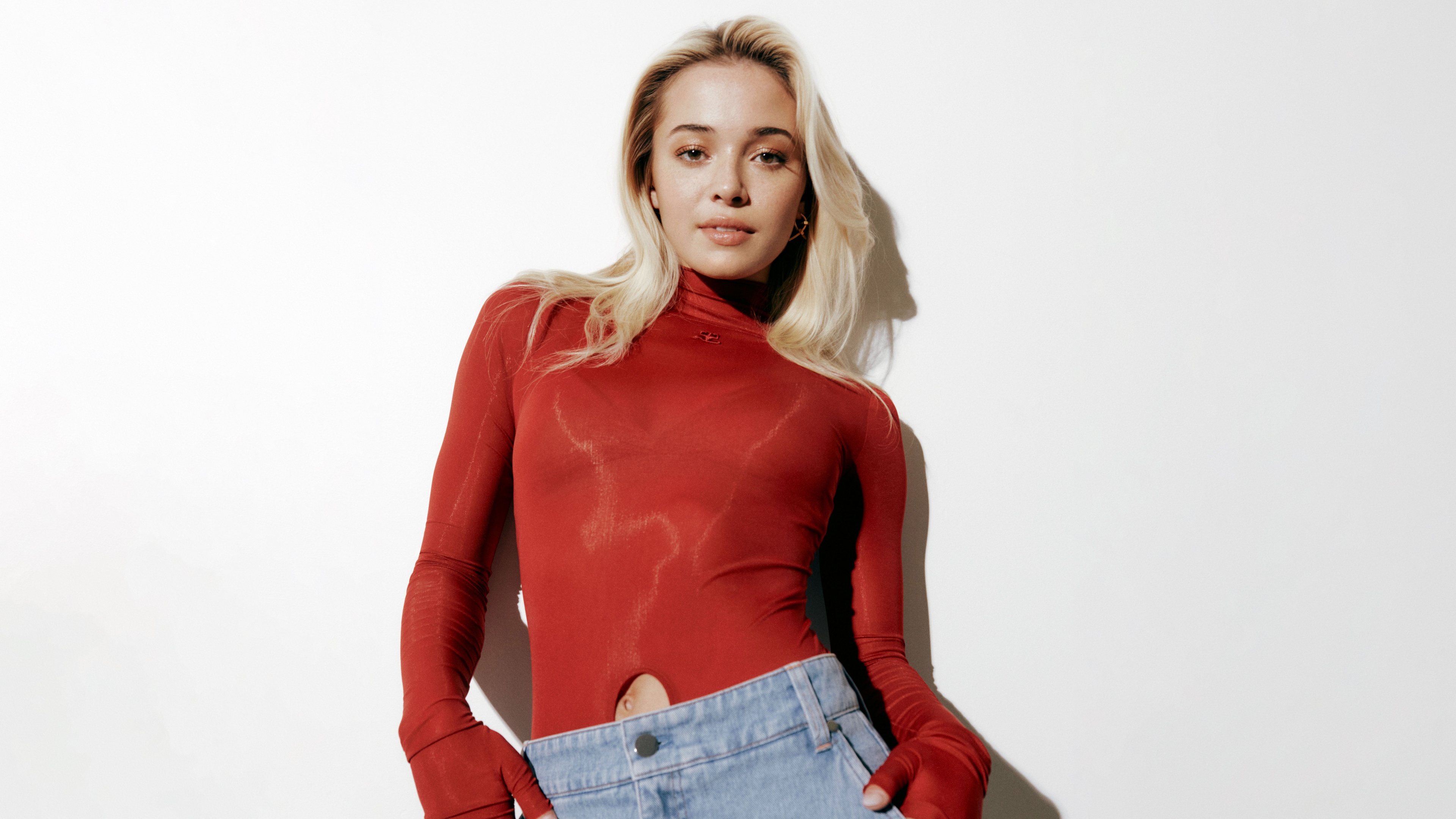 A high-resolution portrait of Olivia Dunne wearing a beautiful red dress