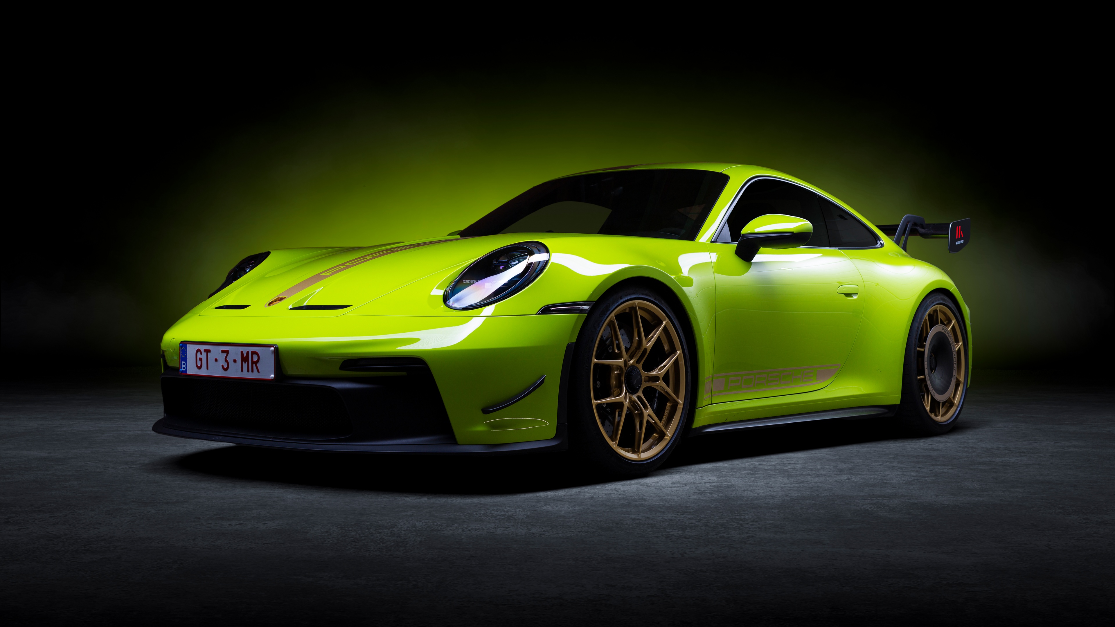 A high-detail 5K shot of a Porsche 911 GT3 performance car against a dark, minimalist background.