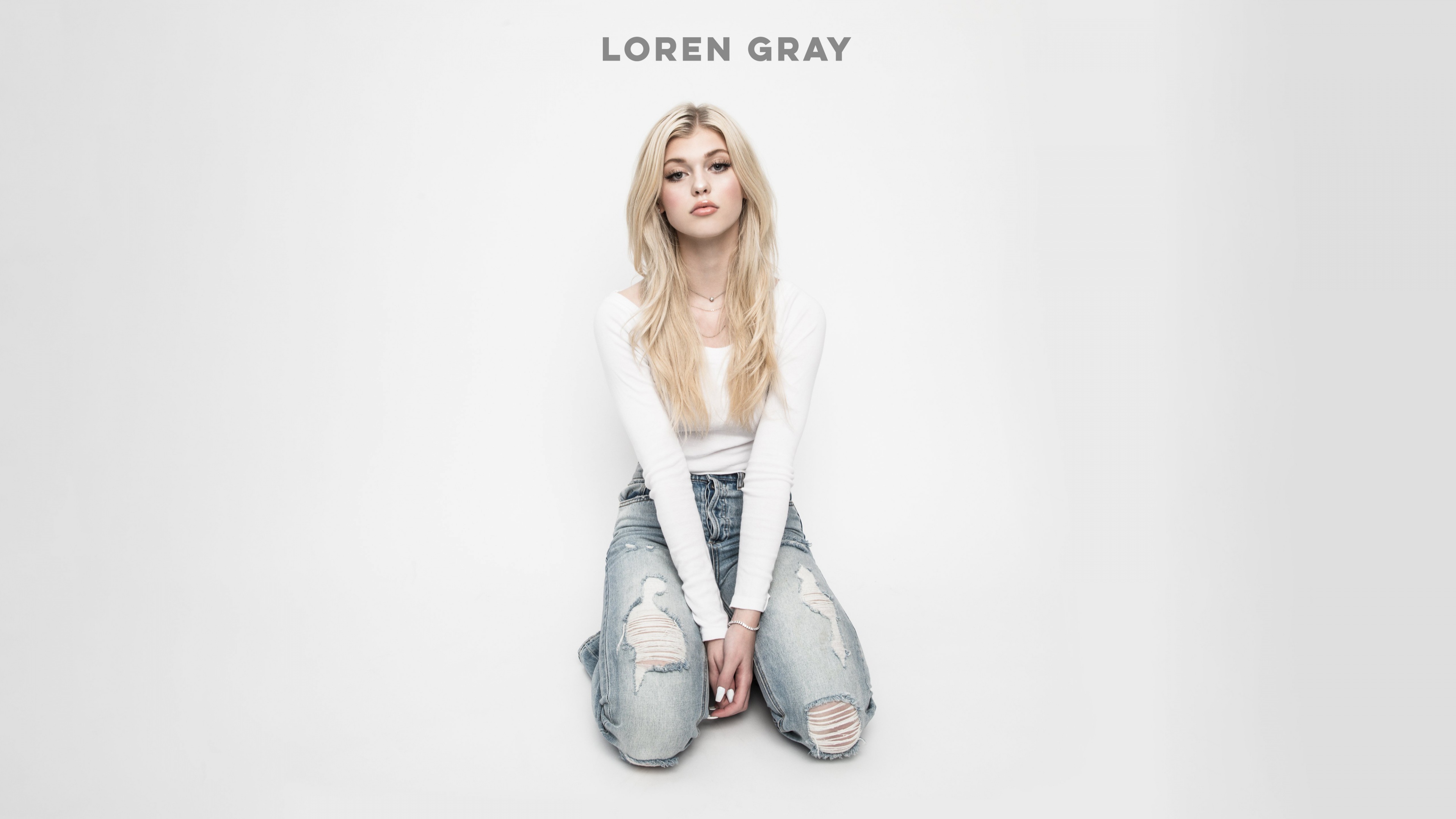 A professional studio portrait of American singer Loren Gray against a solid white background.