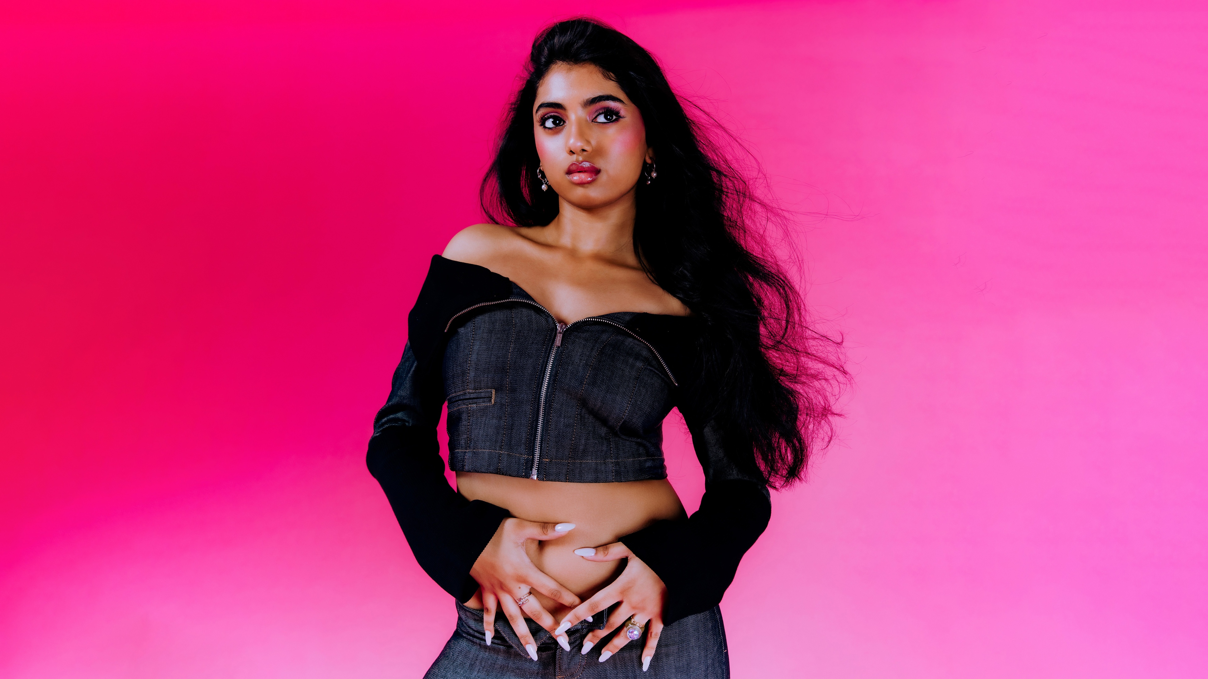 A high-resolution professional portrait of Avantika Vandanapu set against a bright pink backdrop
