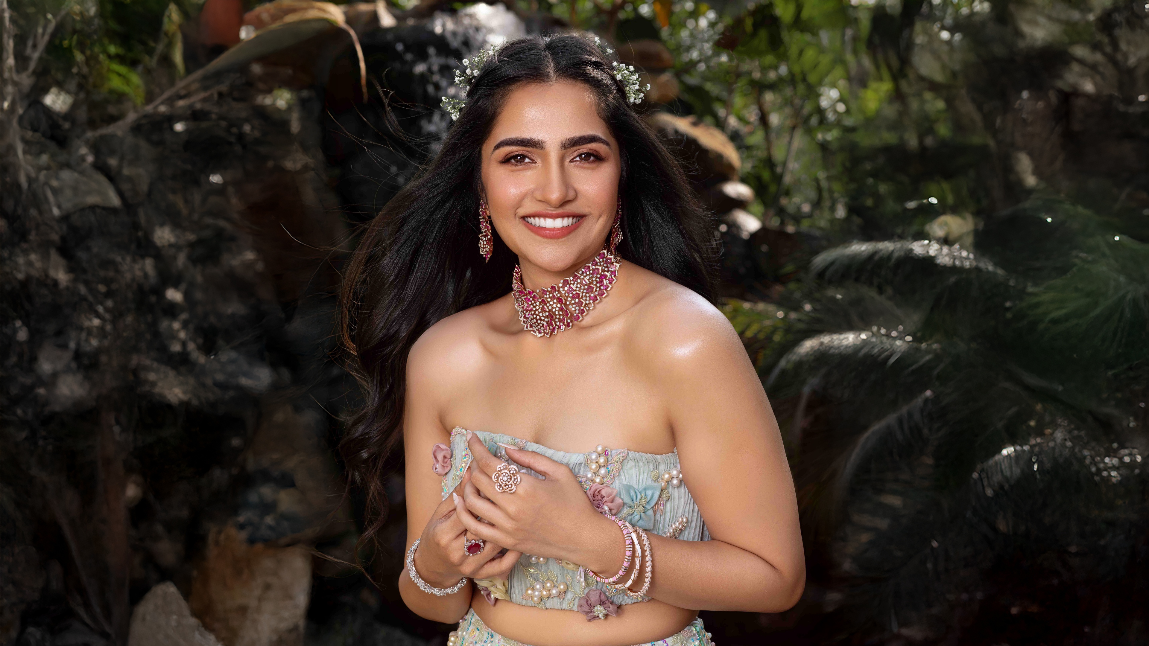 A detailed close-up portrait of smiling Indian actress Rukmini Vasanth.