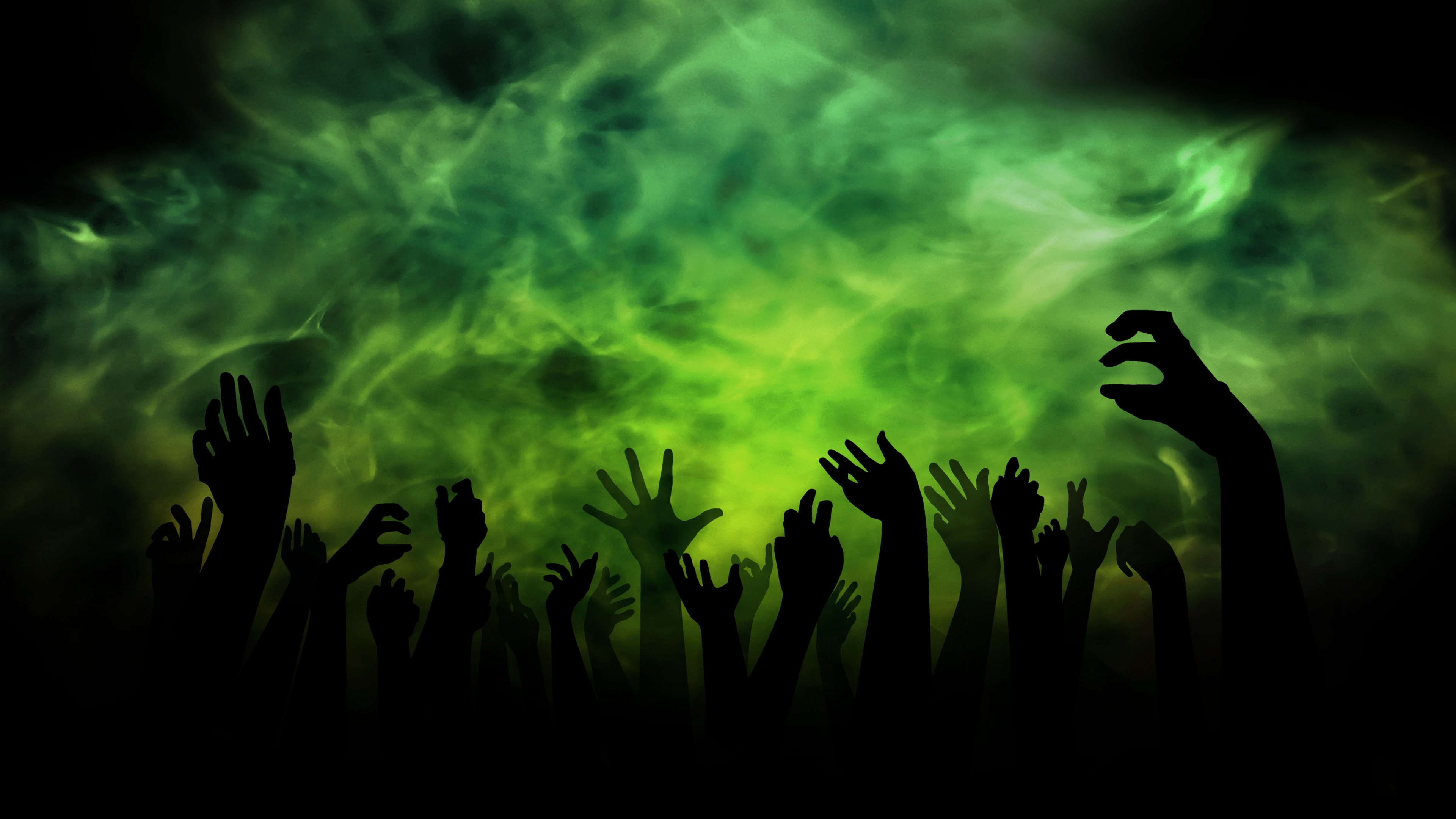 Silhouette of hands surrounded by swirling white smoke on a dark background