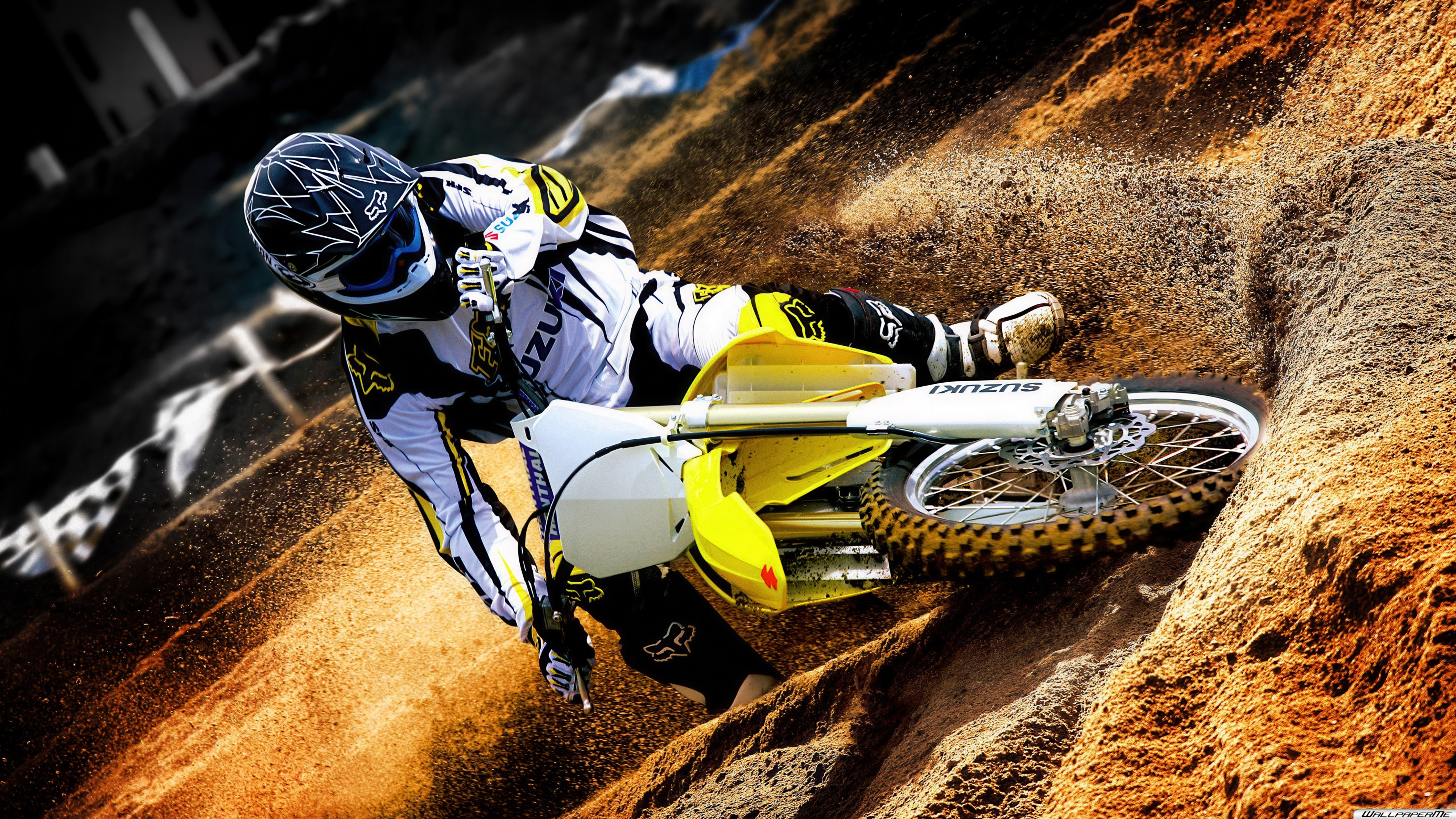 A professional-grade Suzuki RM motocross bike on a dirt track.
