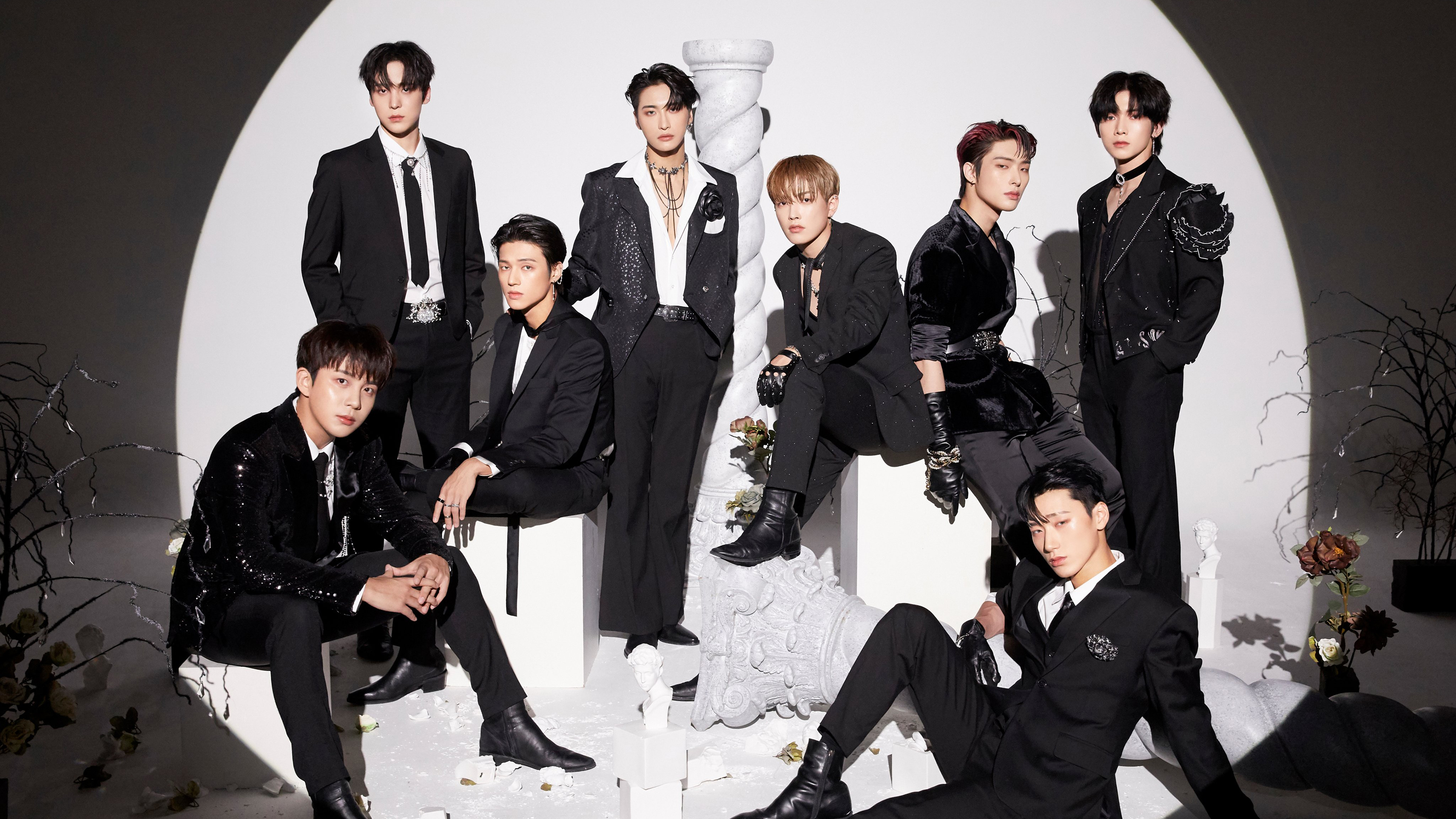 A portrait of the K-pop group ATEEZ members Hongjoong, Seonghwa, Yunho, Yeosang, San, Mingi, Wooyoung, and Jongho.