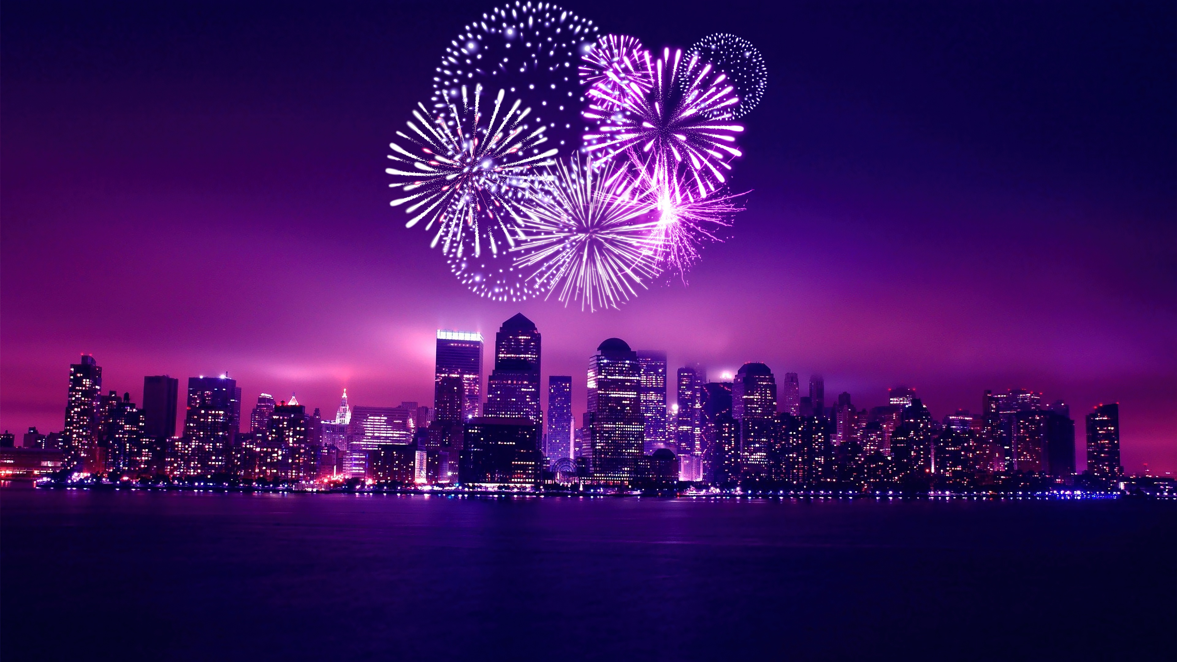A purple-toned night cityscape of Chicago featuring fireworks over the skyline during New Year's Eve celebrations.