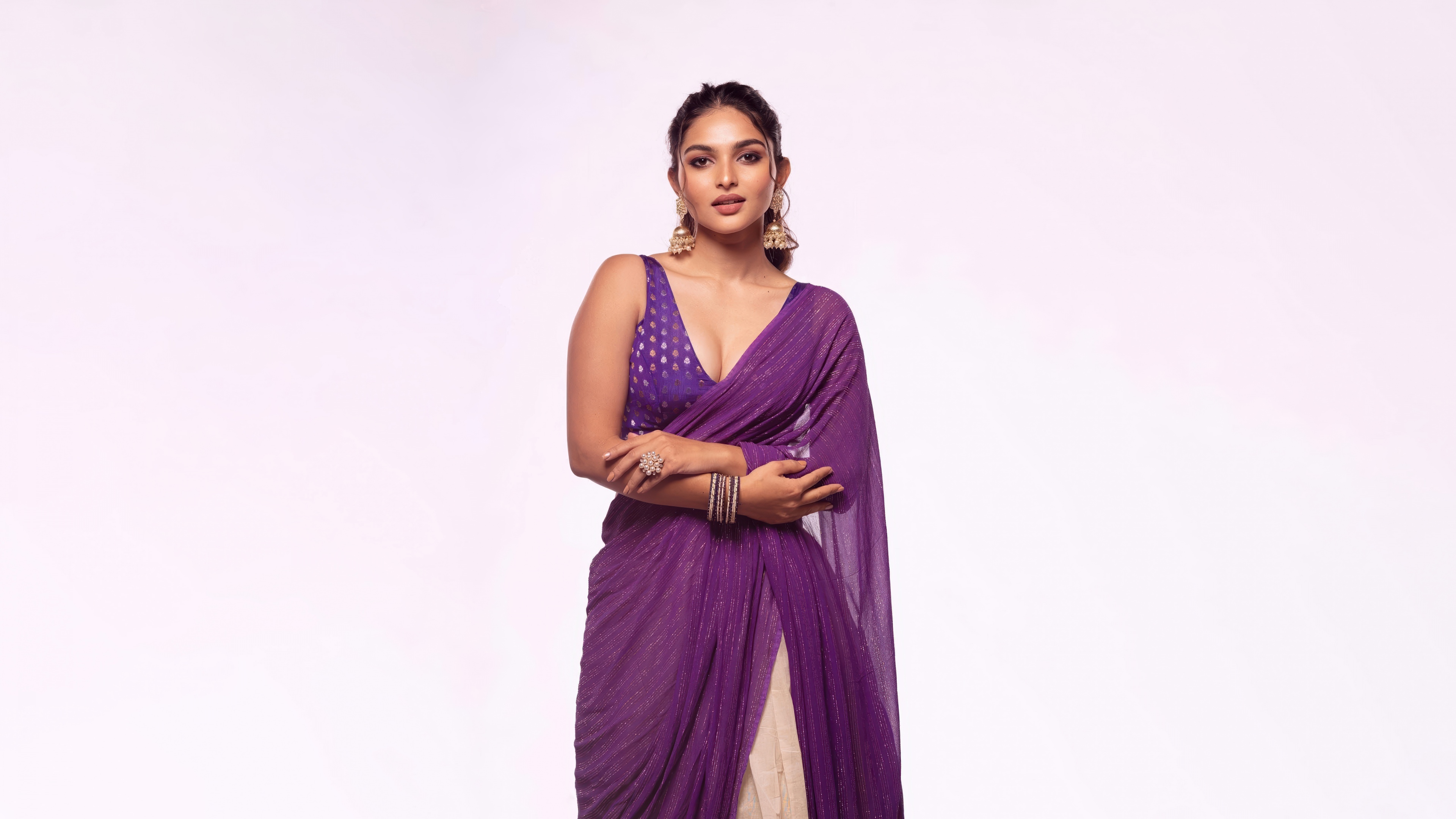 Indian actress Kayadu Lohar wearing a beautiful purple traditional dress against a white background
