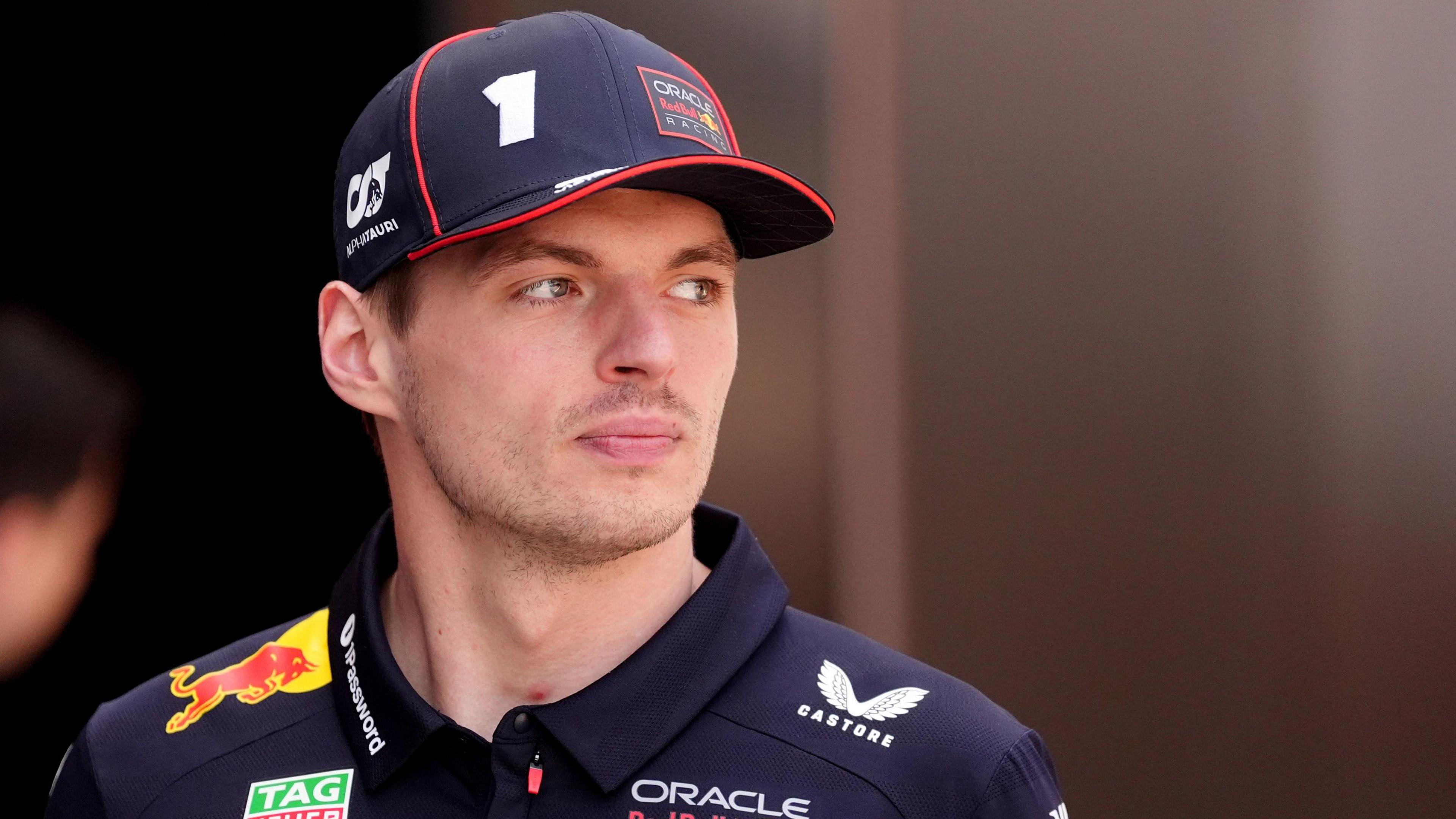 A detailed close-up portrait of racing driver Max Verstappen.