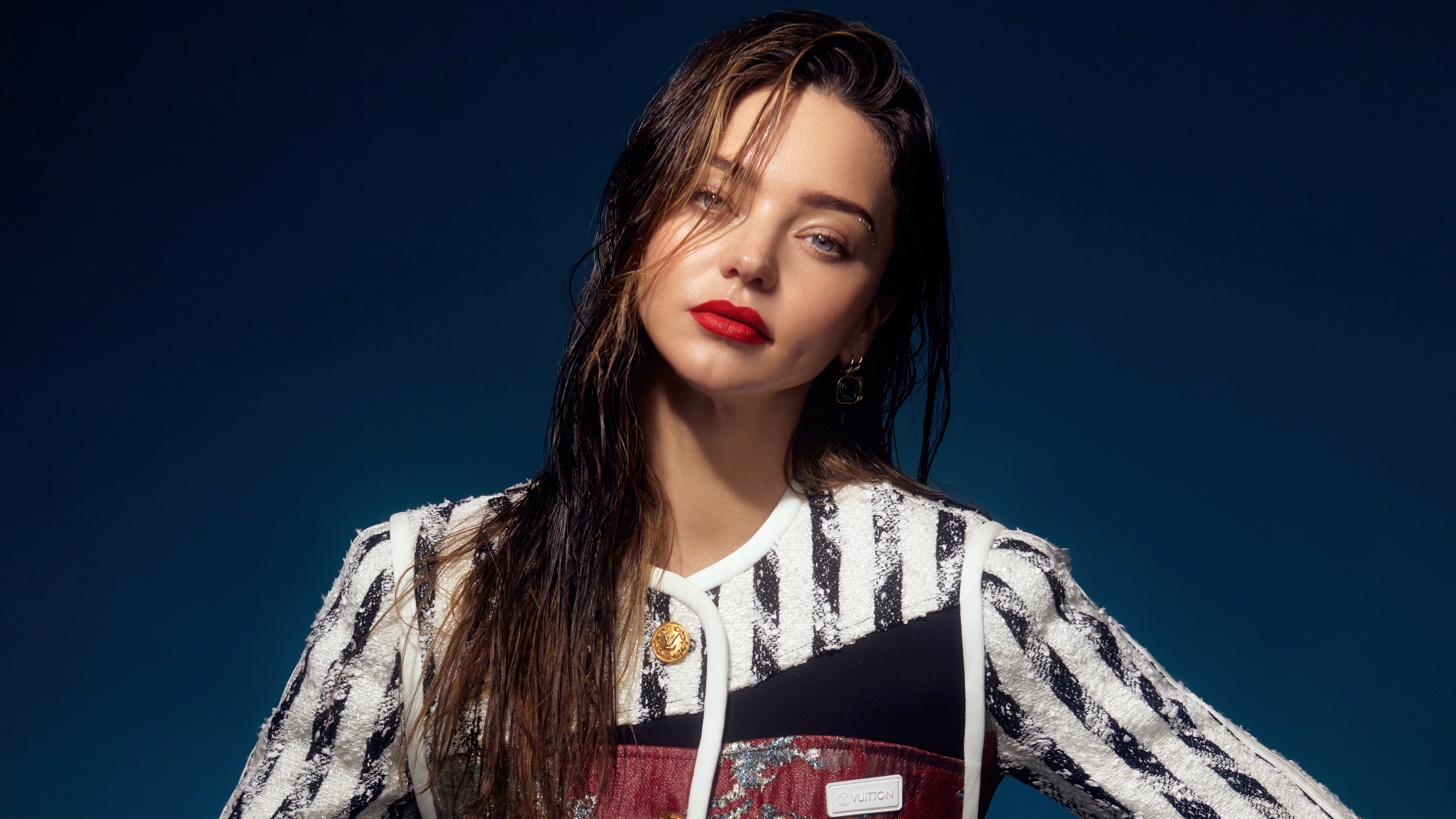 A glamorous fashion portrait of Miranda Kerr featuring elegant styling and high-fashion makeup.
