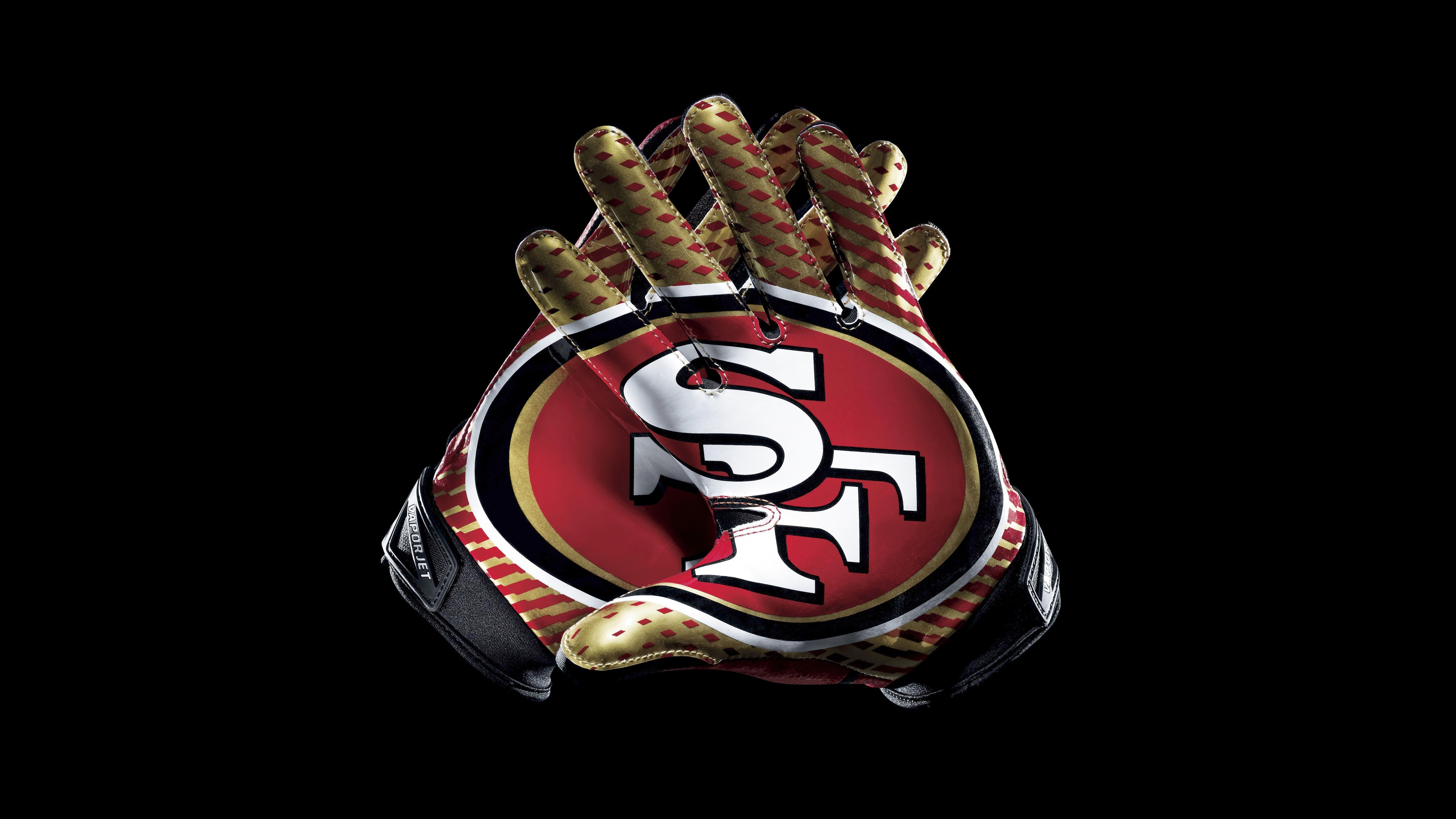 Detailed close-up of San Francisco 49ers football gloves against a black background