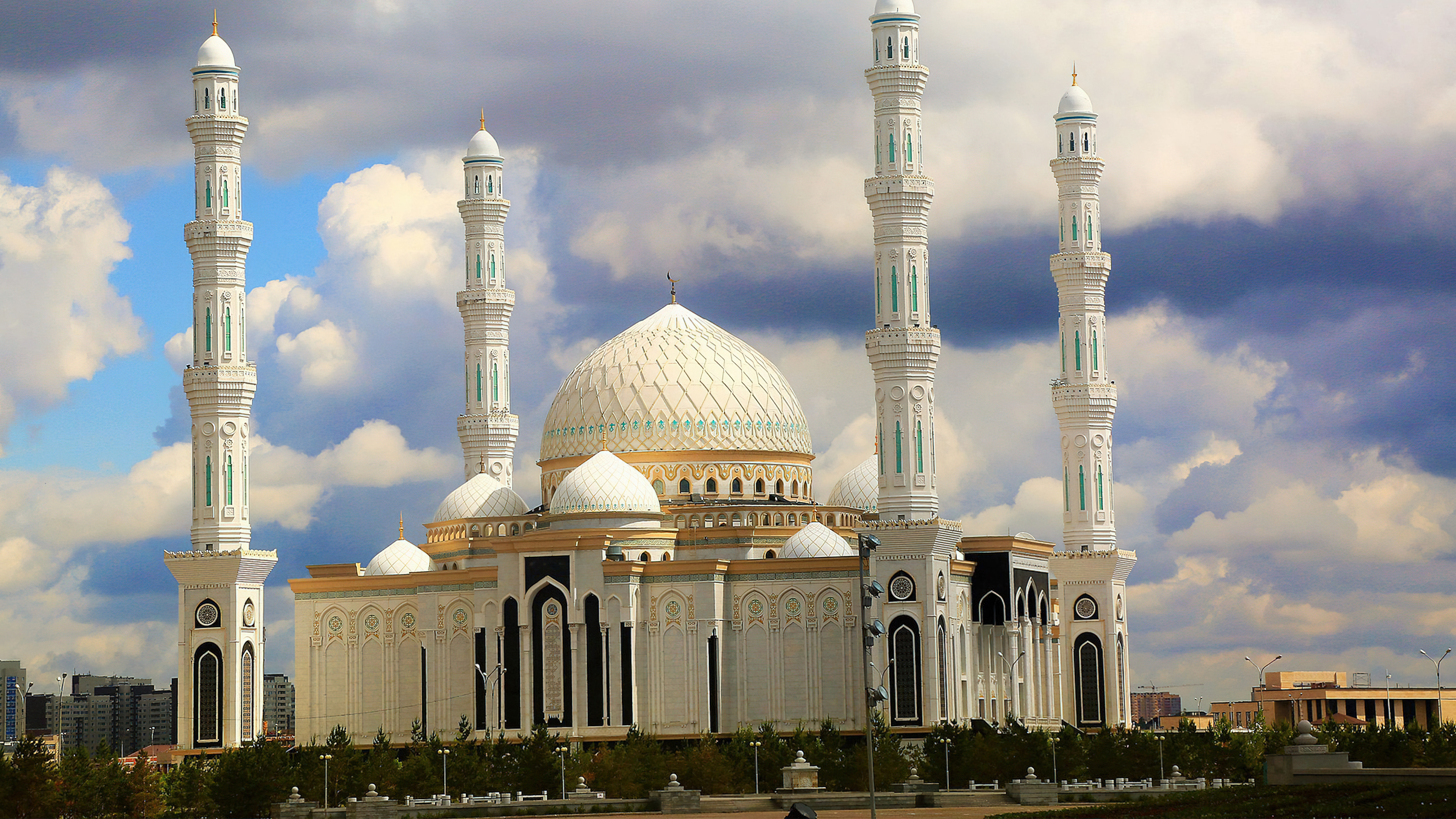 An exquisite view of a mosque with glowing lanterns and a crescent moon in a tranquil night setting.