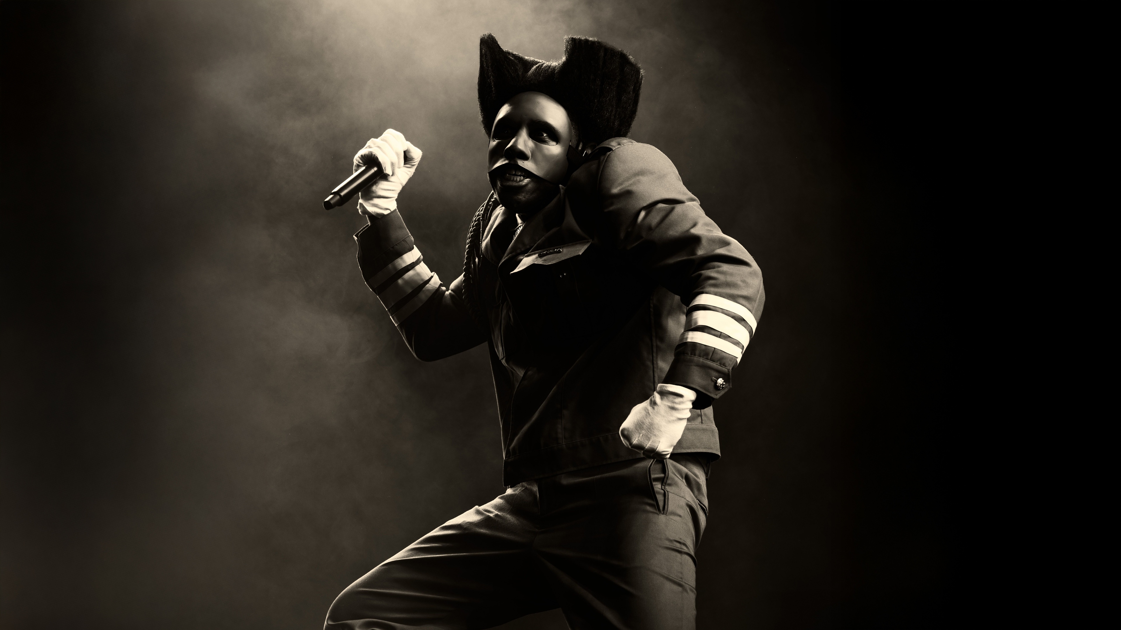 A high-contrast, monochrome 8K portrait of American rapper Tyler, The Creator set against a dark background.