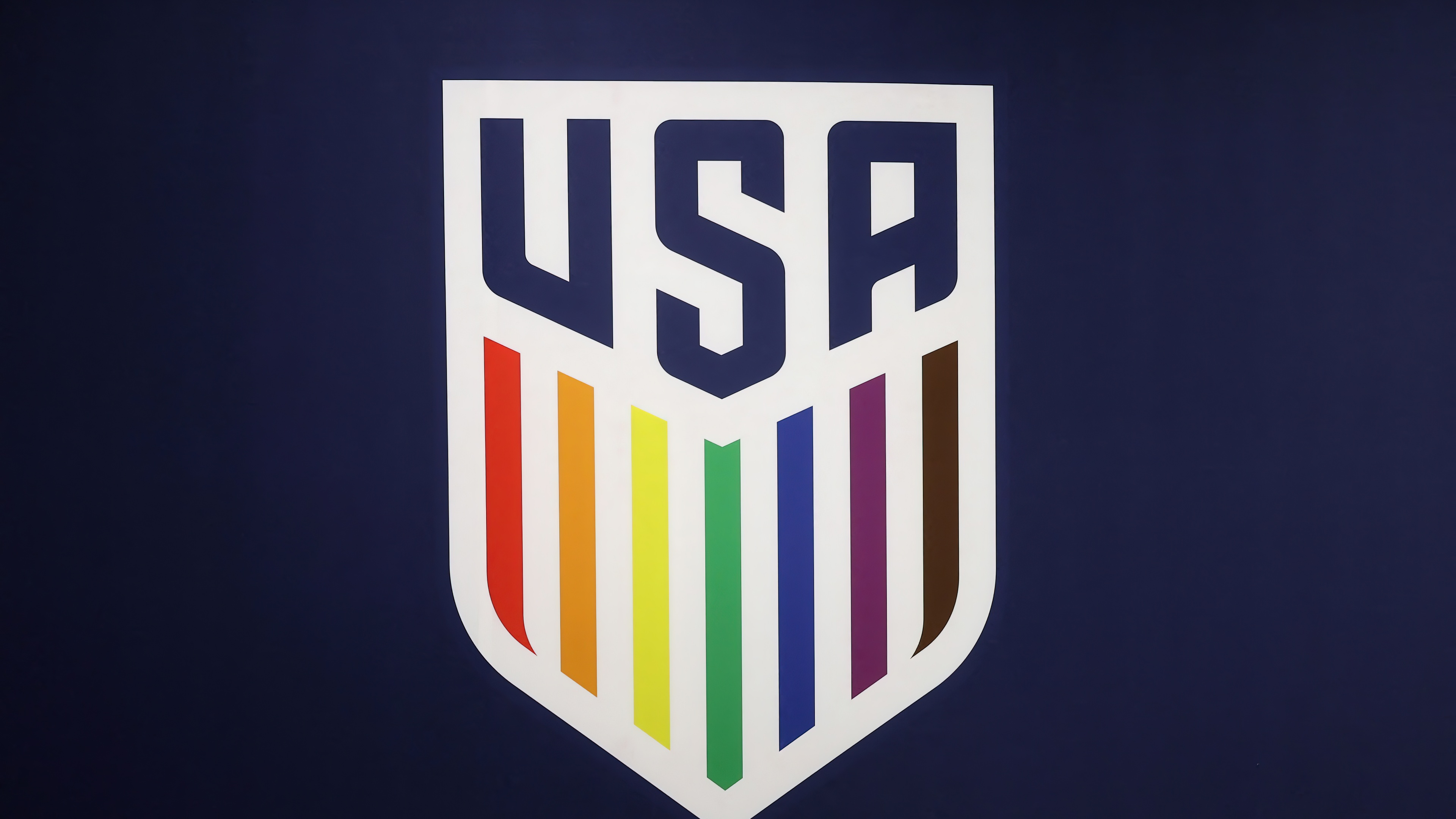 The United States Men's National Soccer Team (USMNT) logo centered on a solid purple background.