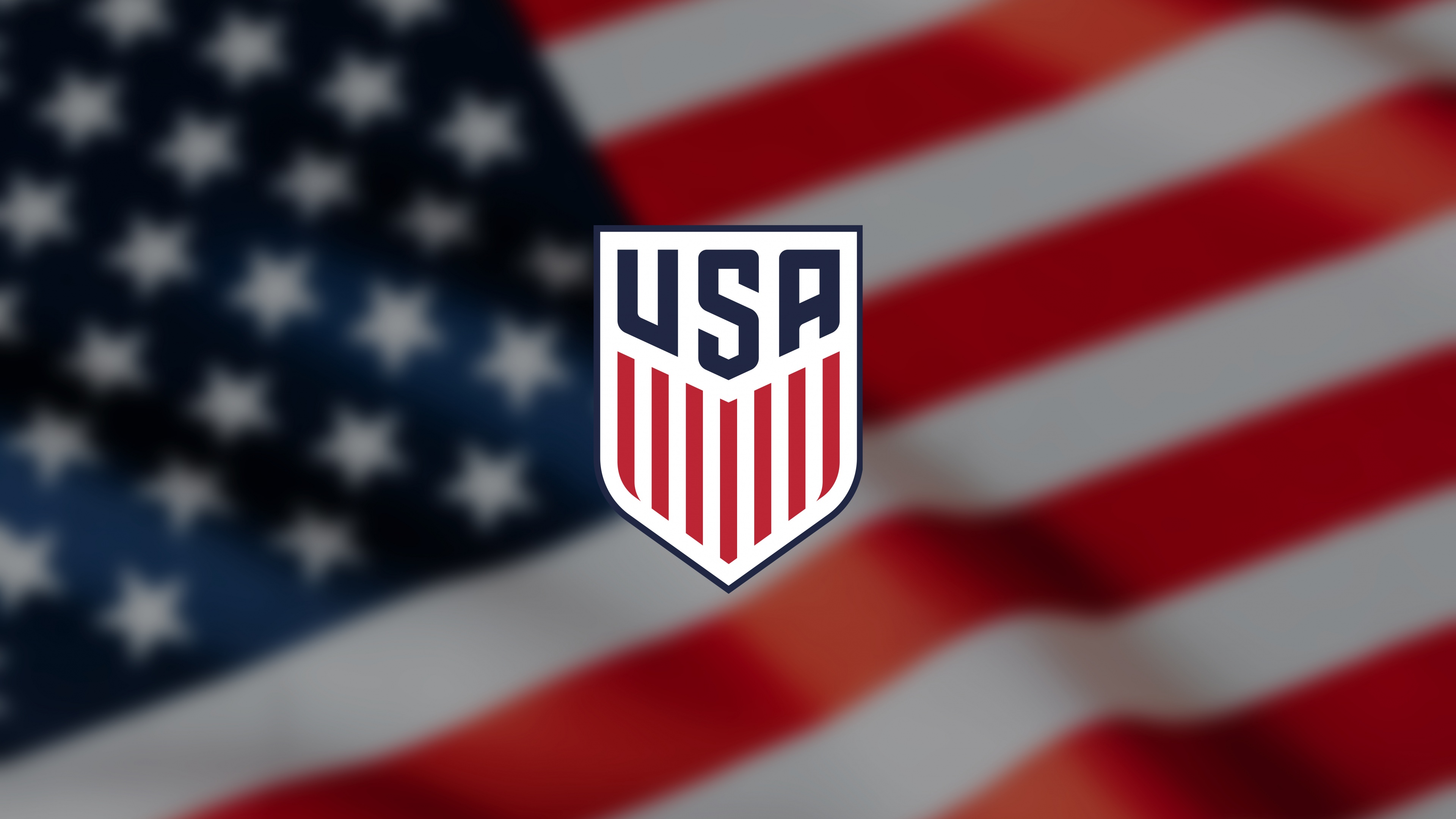 USMNT logo overlaid on a waving United States flag background.