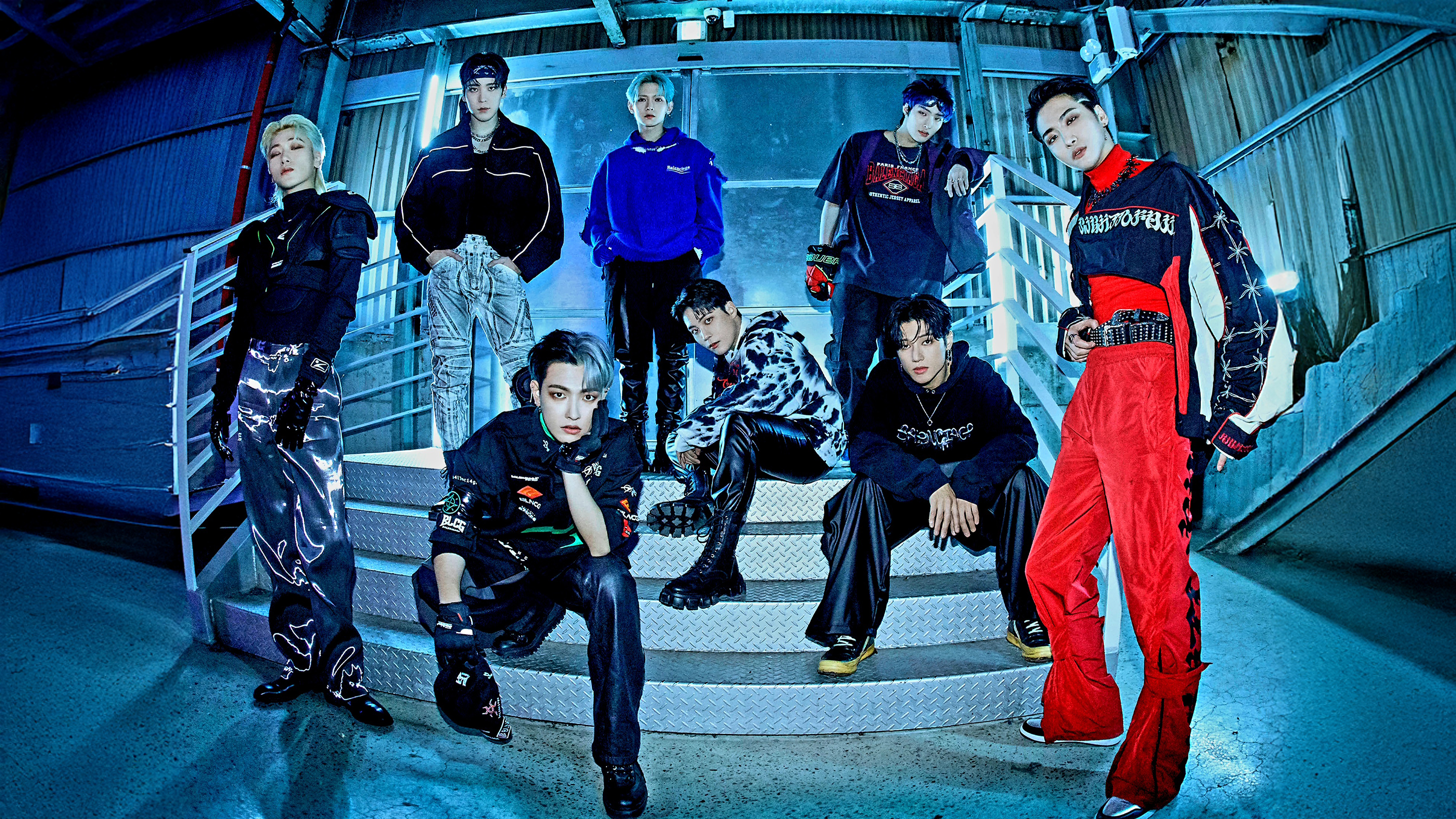 A professional group portrait of the K-pop boy band ATEEZ members: Hongjoong, Seonghwa, Yunho, Yeosang, San, Mingi, Wooyoung, and Jongho.