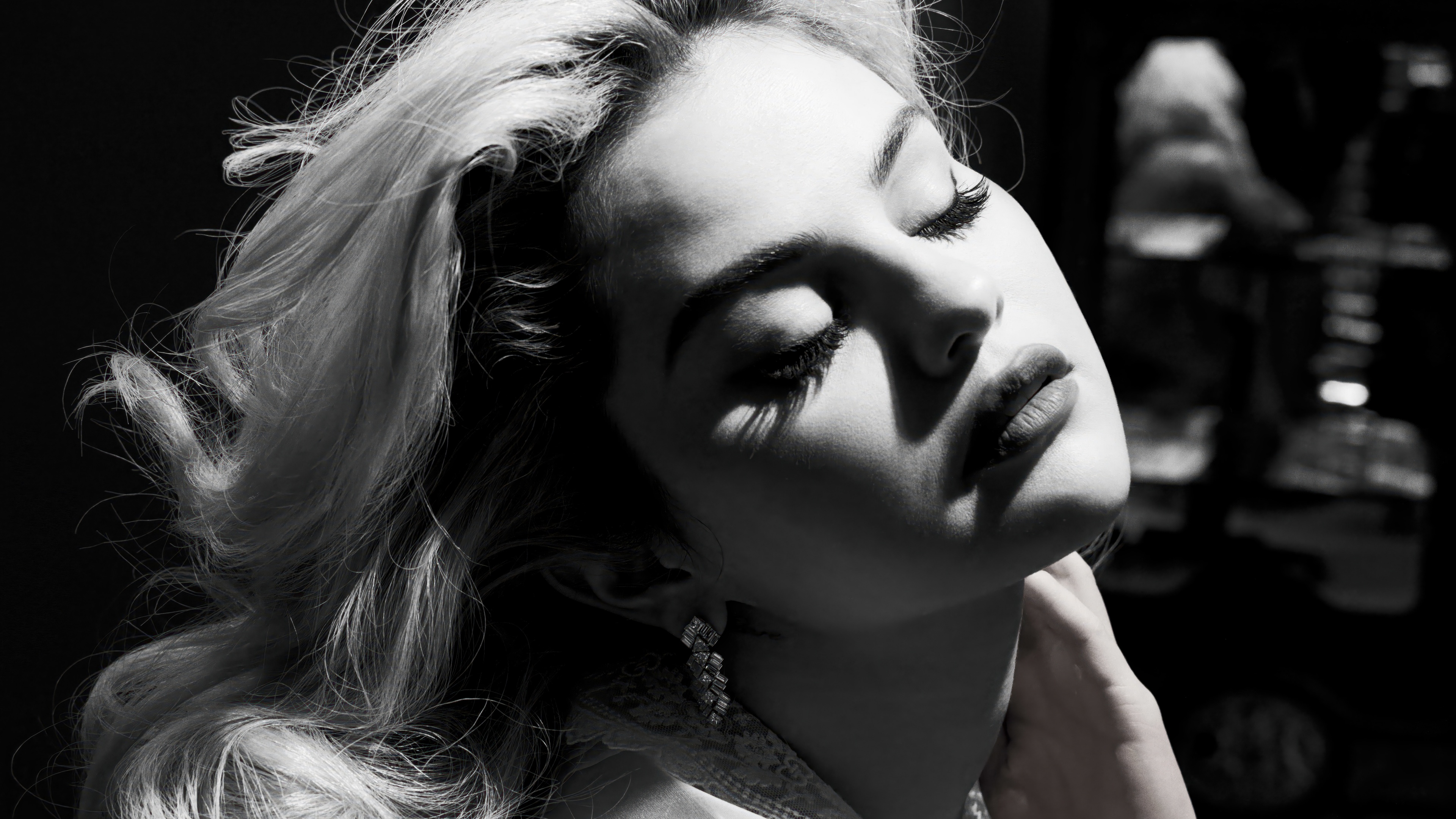 A high-resolution, black and white professional photoshoot portrait of Selena Gomez.