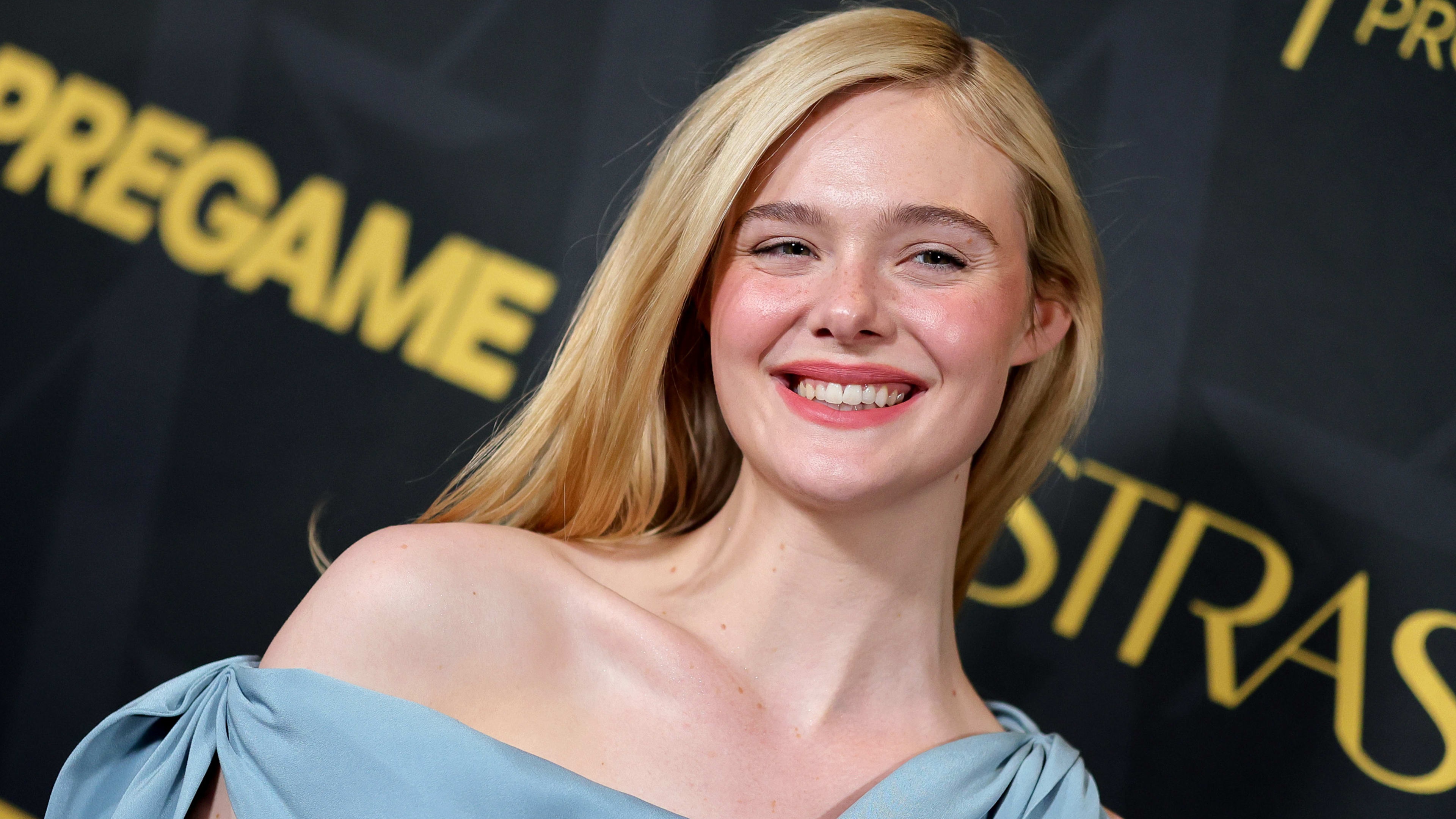 A smiling portrait of actress Elle Fanning.