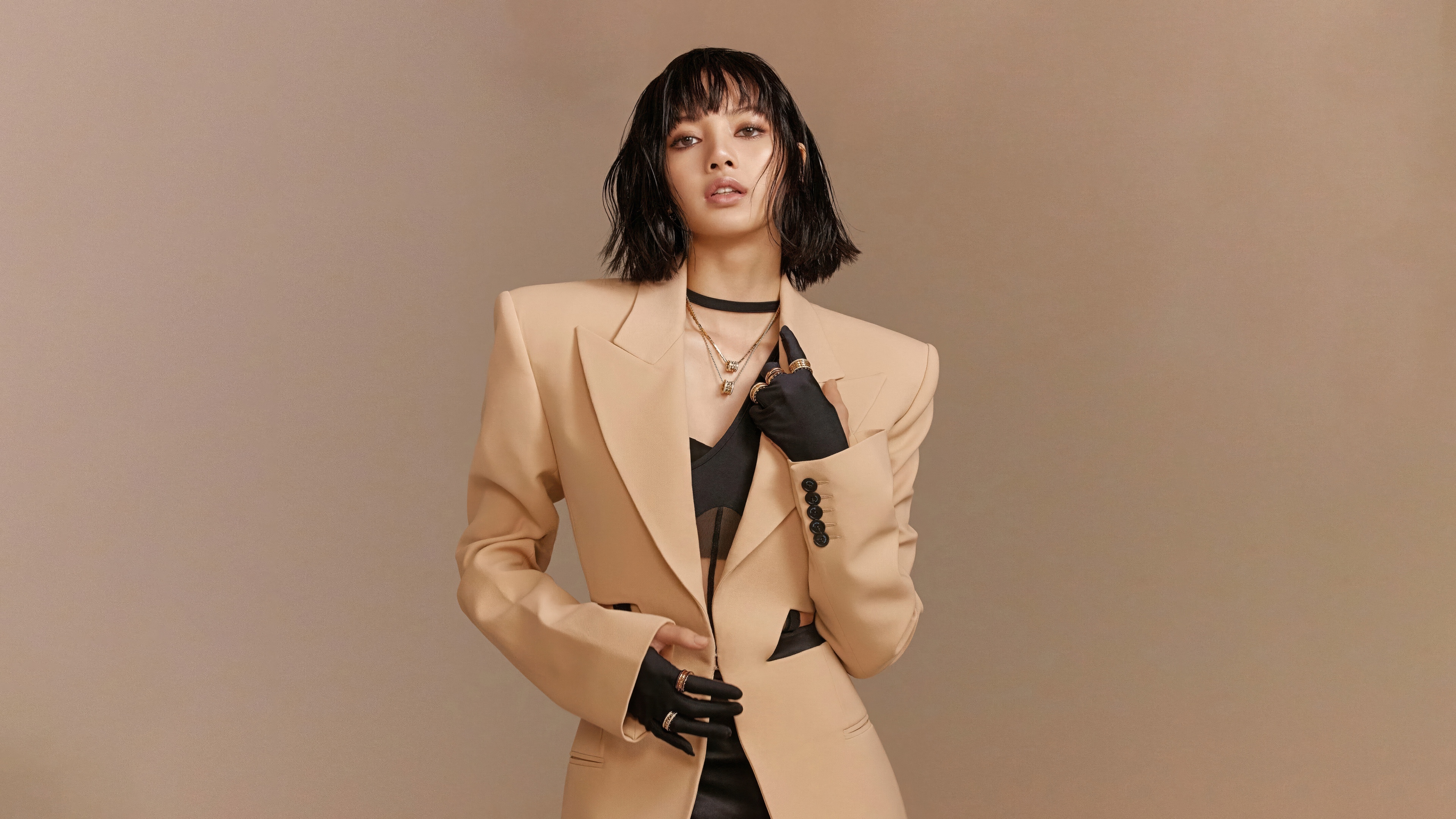 High-fashion editorial portrait of Lisa wearing beige luxury attire in the style of Vogue Magazine.