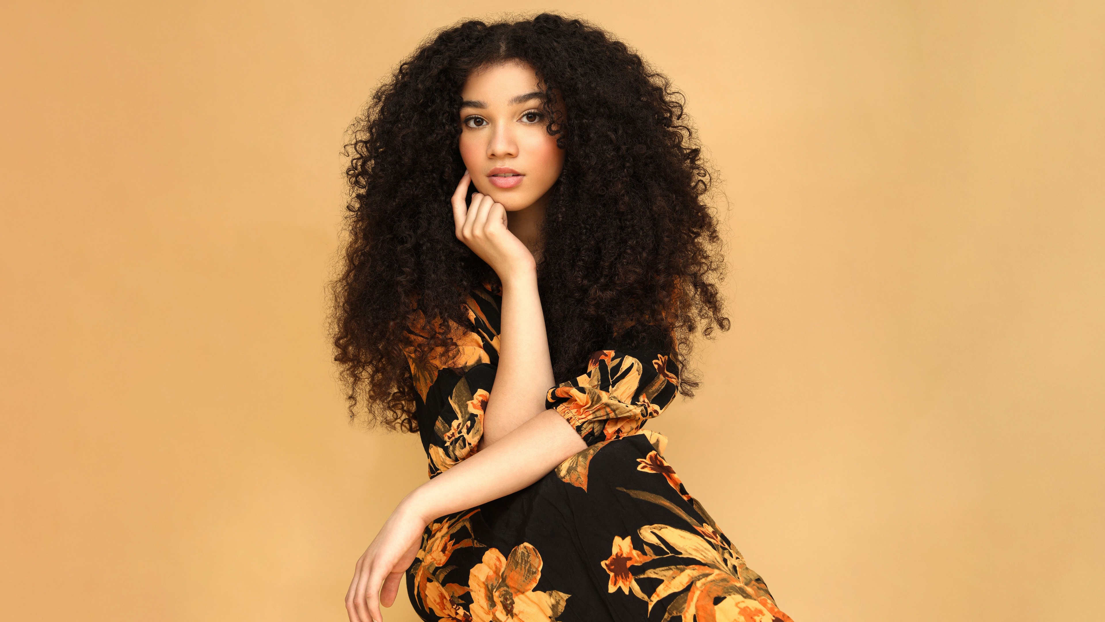A beautiful portrait of Canadian actress Malia Baker featuring soft pastel yellow tones.