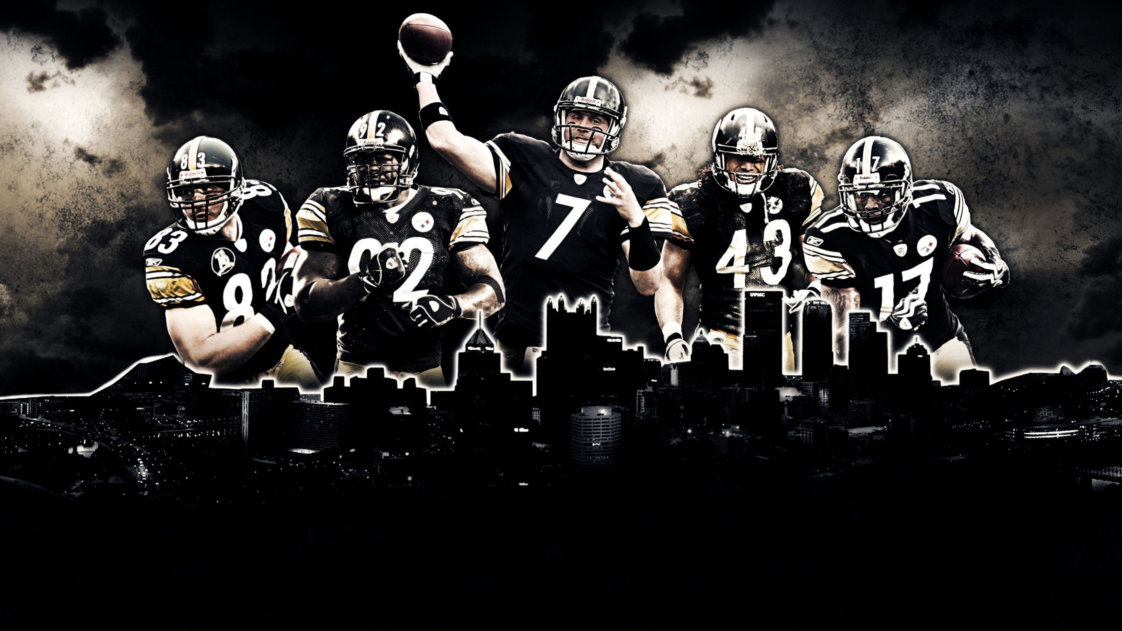 A high-action view of the Pittsburgh Steelers football team wearing their signature black and gold uniforms.