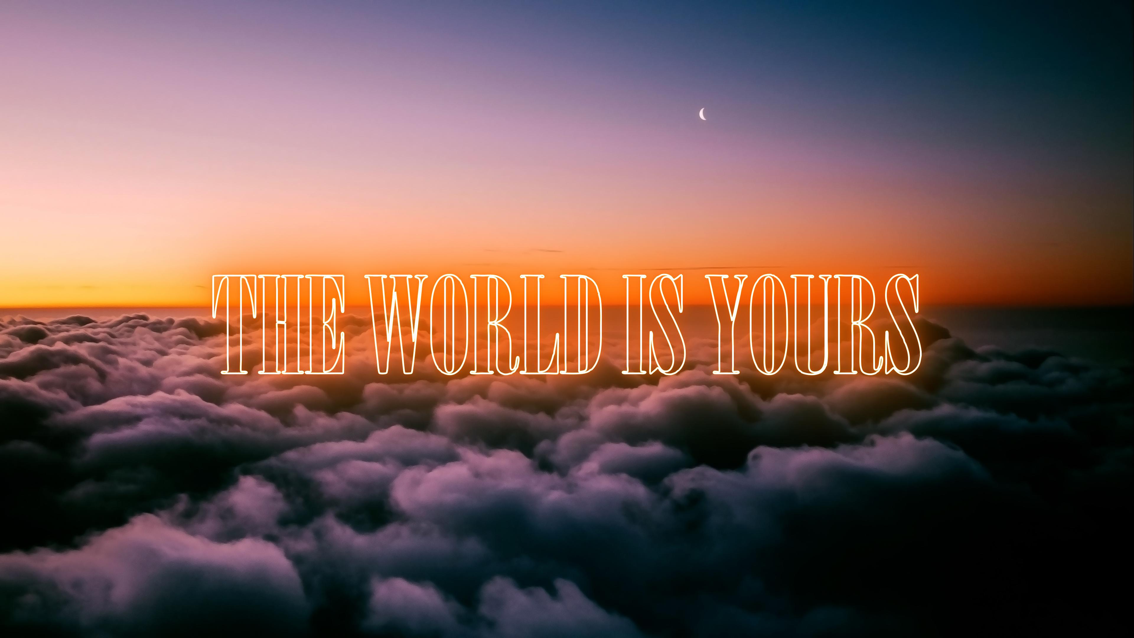 A lone traveler overlooking a vast sea of clouds during a bright day, with the inspirational text 'The World is Yours' overlaid on the sky.