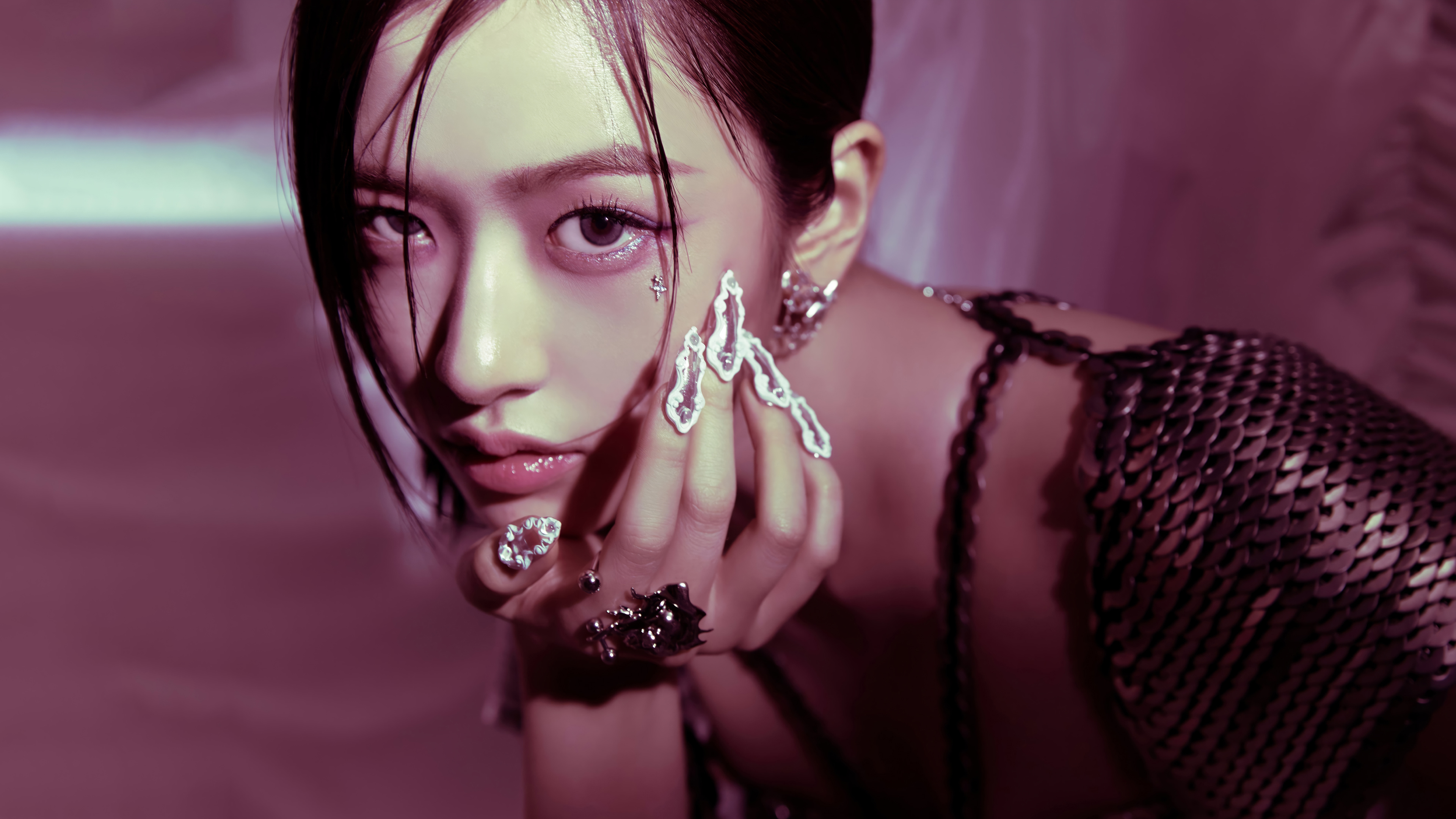 An Yujin from the K-pop group IVE posing in a soft pink aesthetic setting.