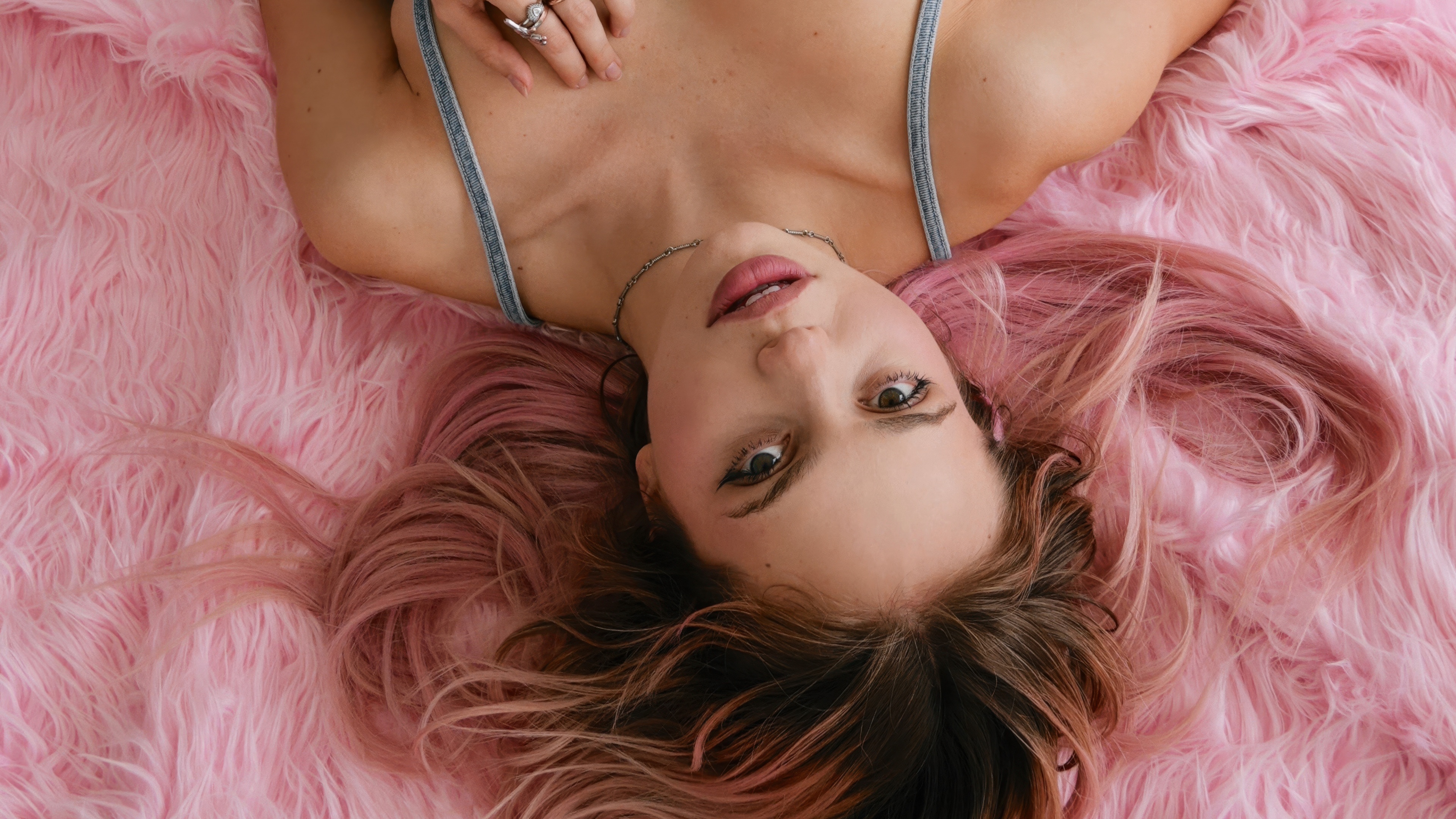 A stylish young female singer featured in a high-fashion magazine editorial portrait.