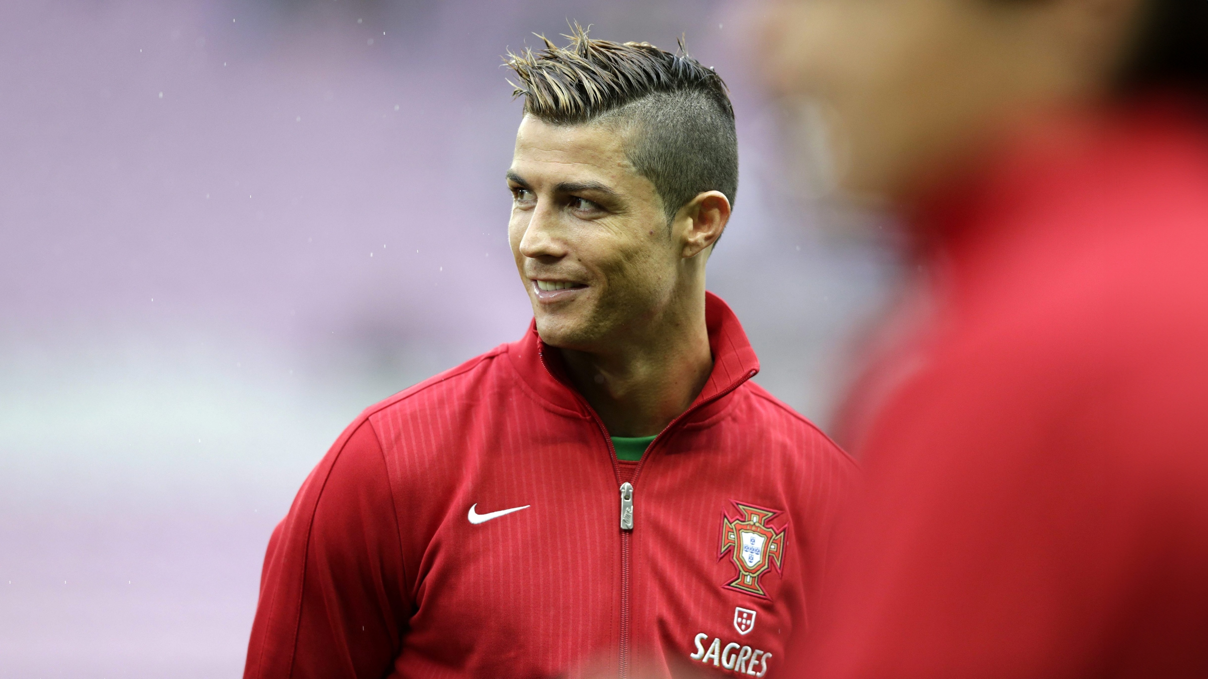 Cristiano Ronaldo smiling brightly, representing the Portugal national football team.