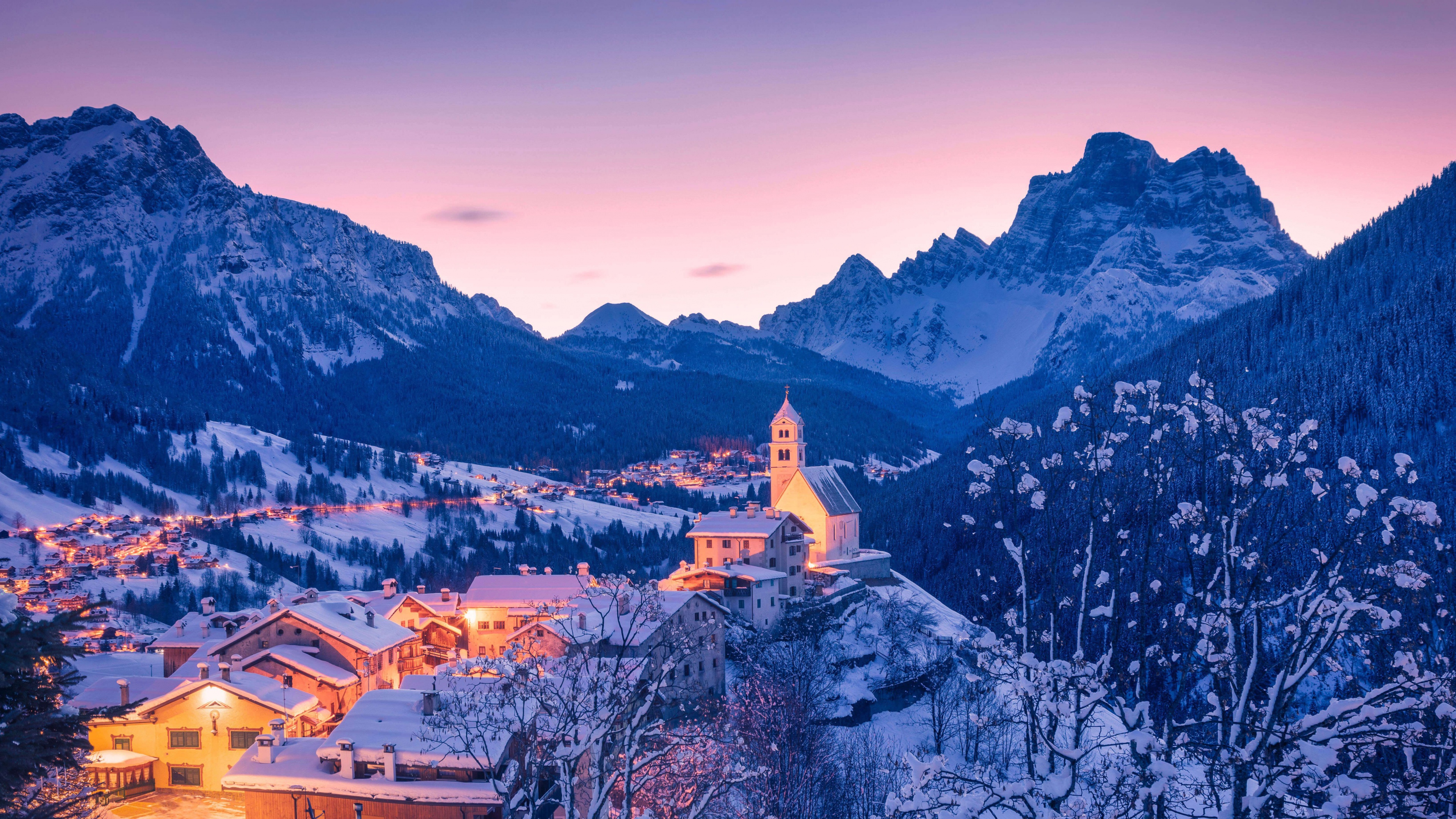 Snow-capped peaks of the Dolomite mountains in Italy during a winter sunrise.