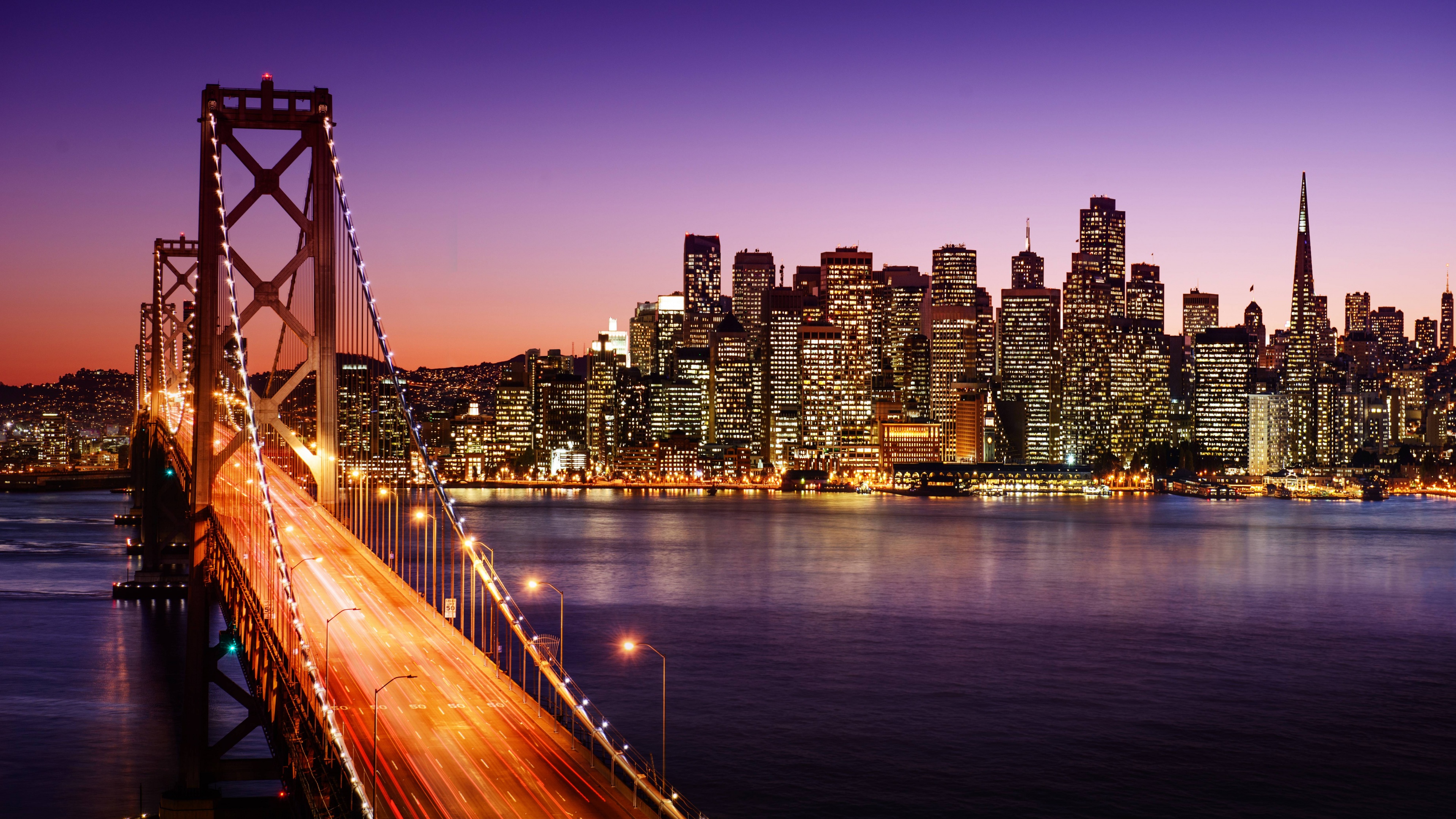 The Golden Gate Bridge illuminated at night under a twilight sky in San Francisco, California.