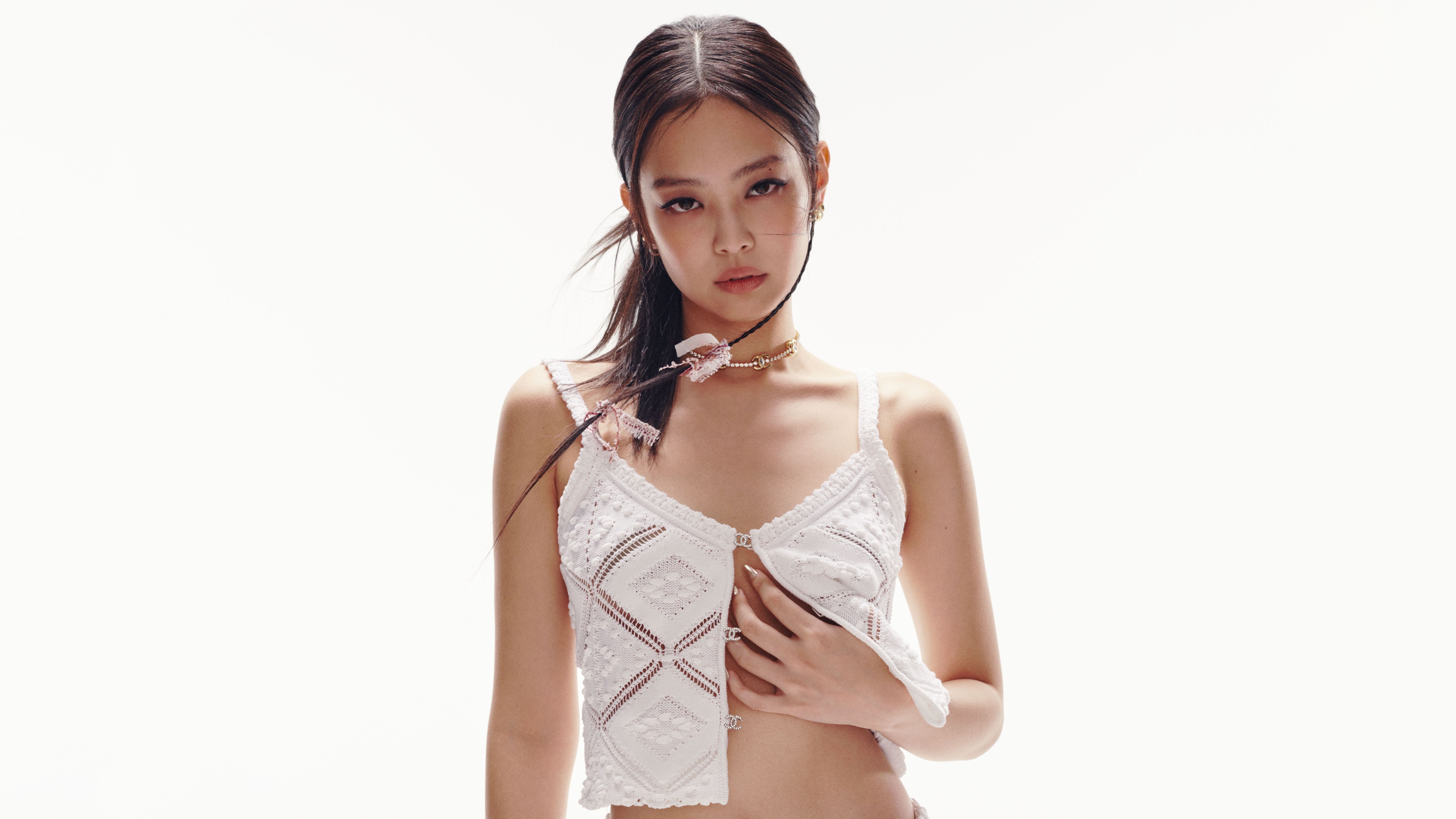 A high-resolution portrait of Jennie Kim from BLACKPINK in a clean, white aesthetic photoshoot setting.