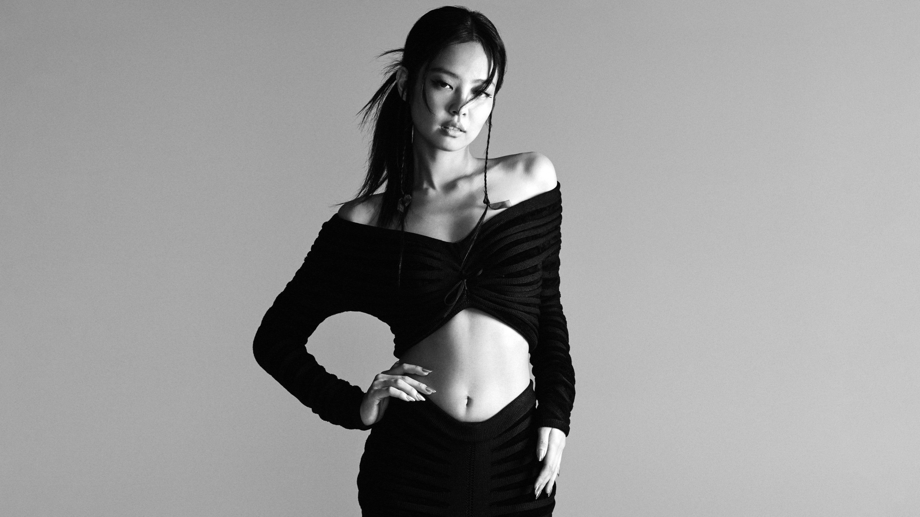 A monochrome, high-fashion editorial portrait of South Korean singer Jennie Kim.