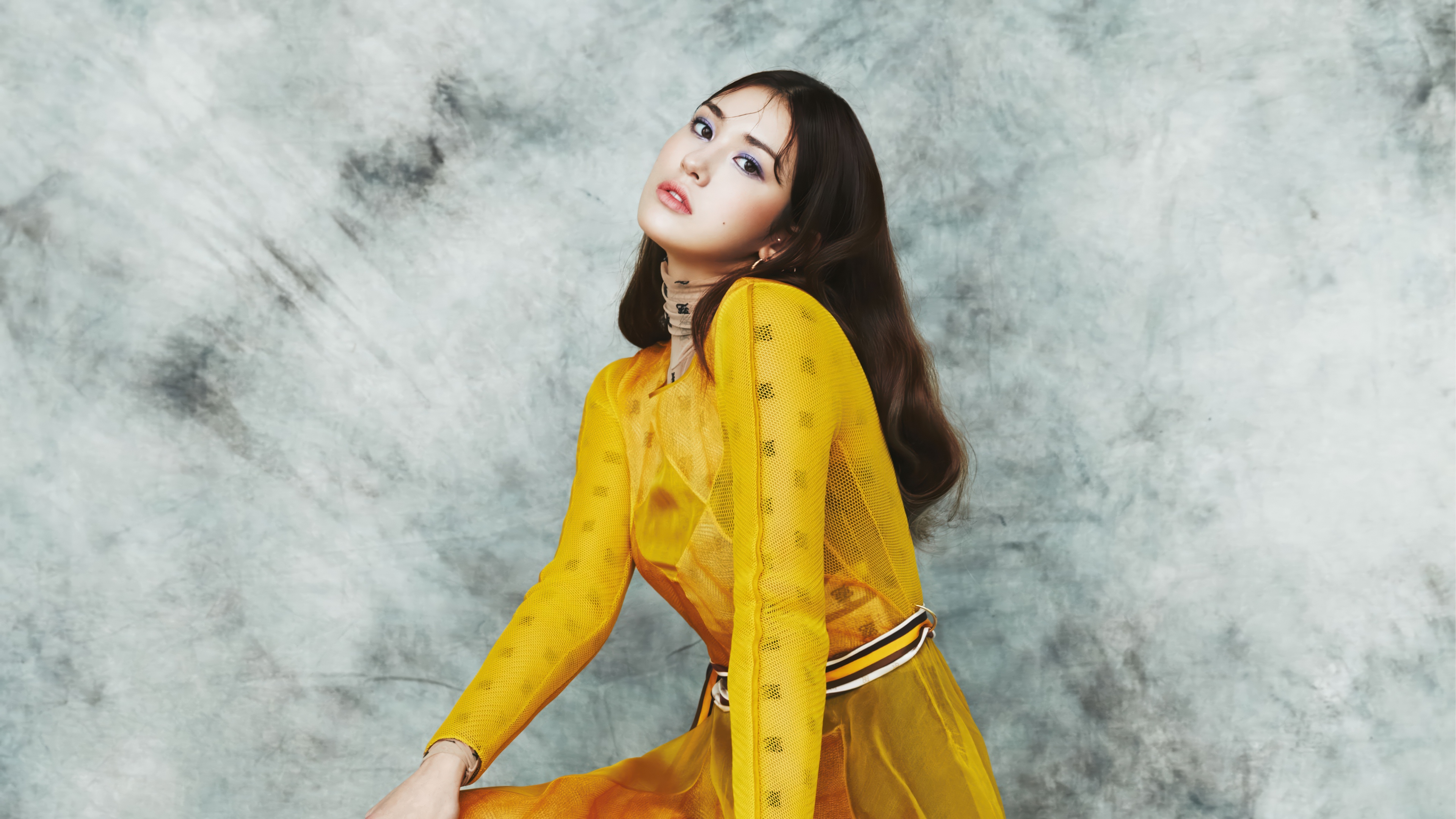 A high-resolution portrait of Jeon Somi wearing a luxurious and elegant yellow fashion dress.