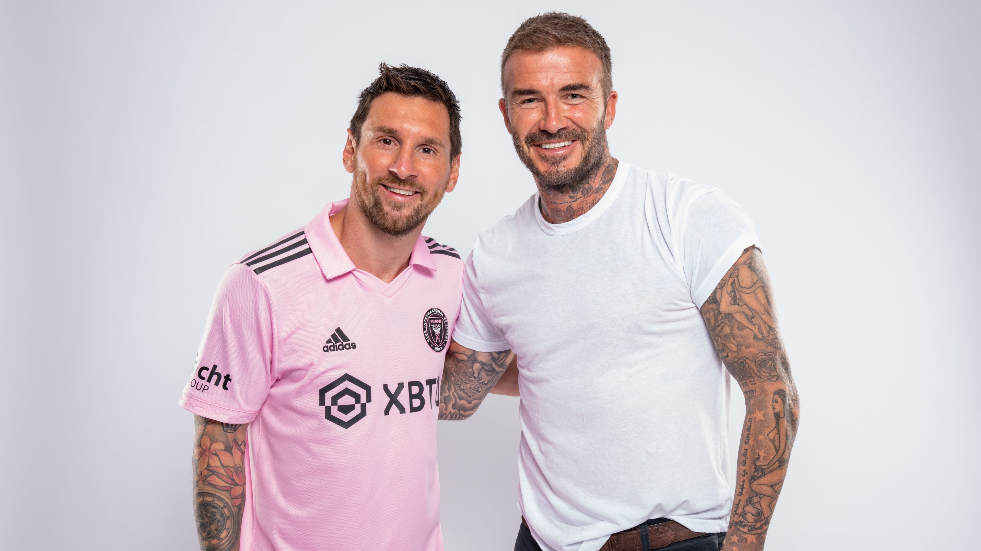 A professional portrait featuring football superstars Lionel Messi and David Beckham.