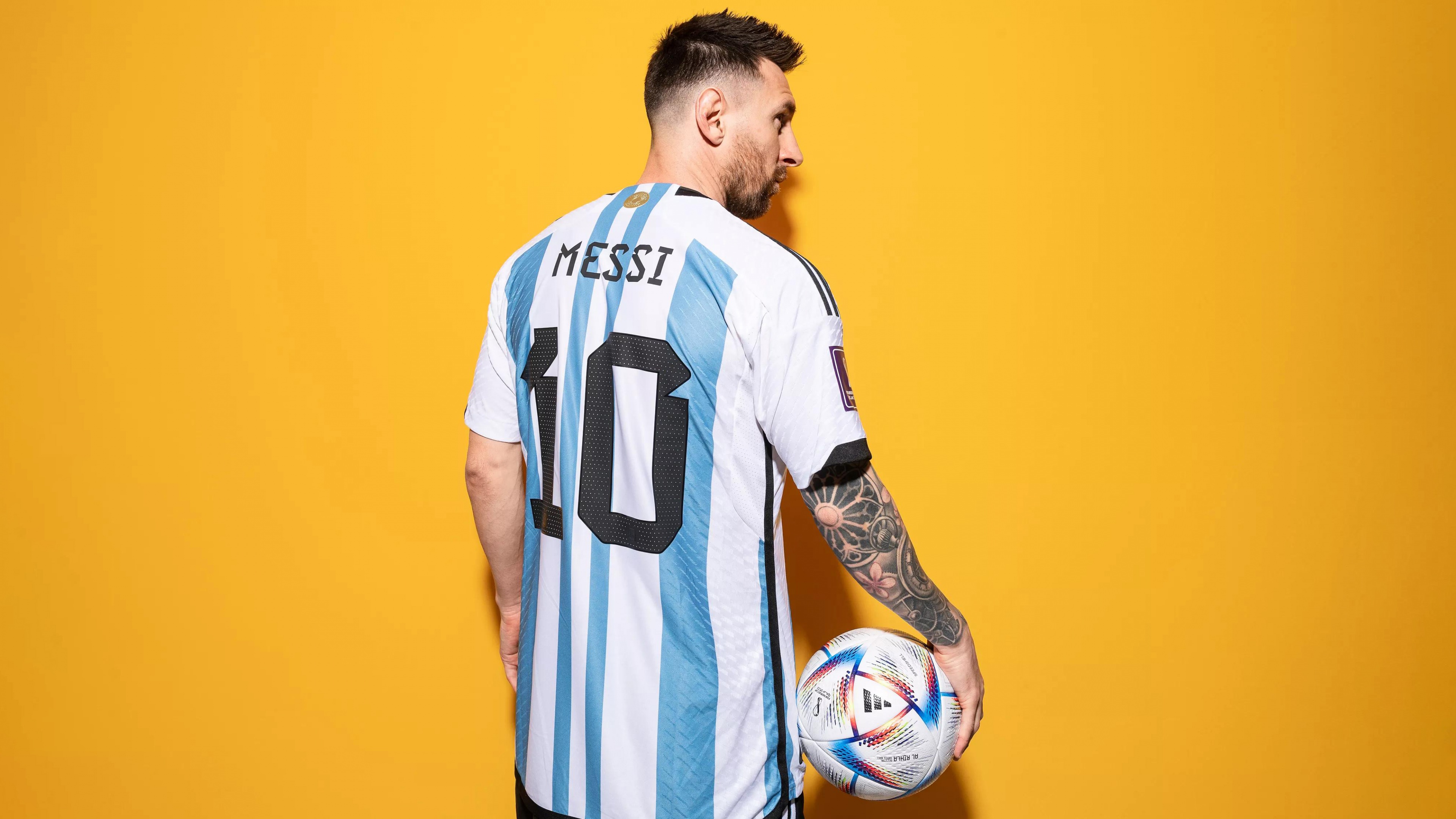 Lionel Messi, the Argentine soccer star, posing against a solid yellow background.