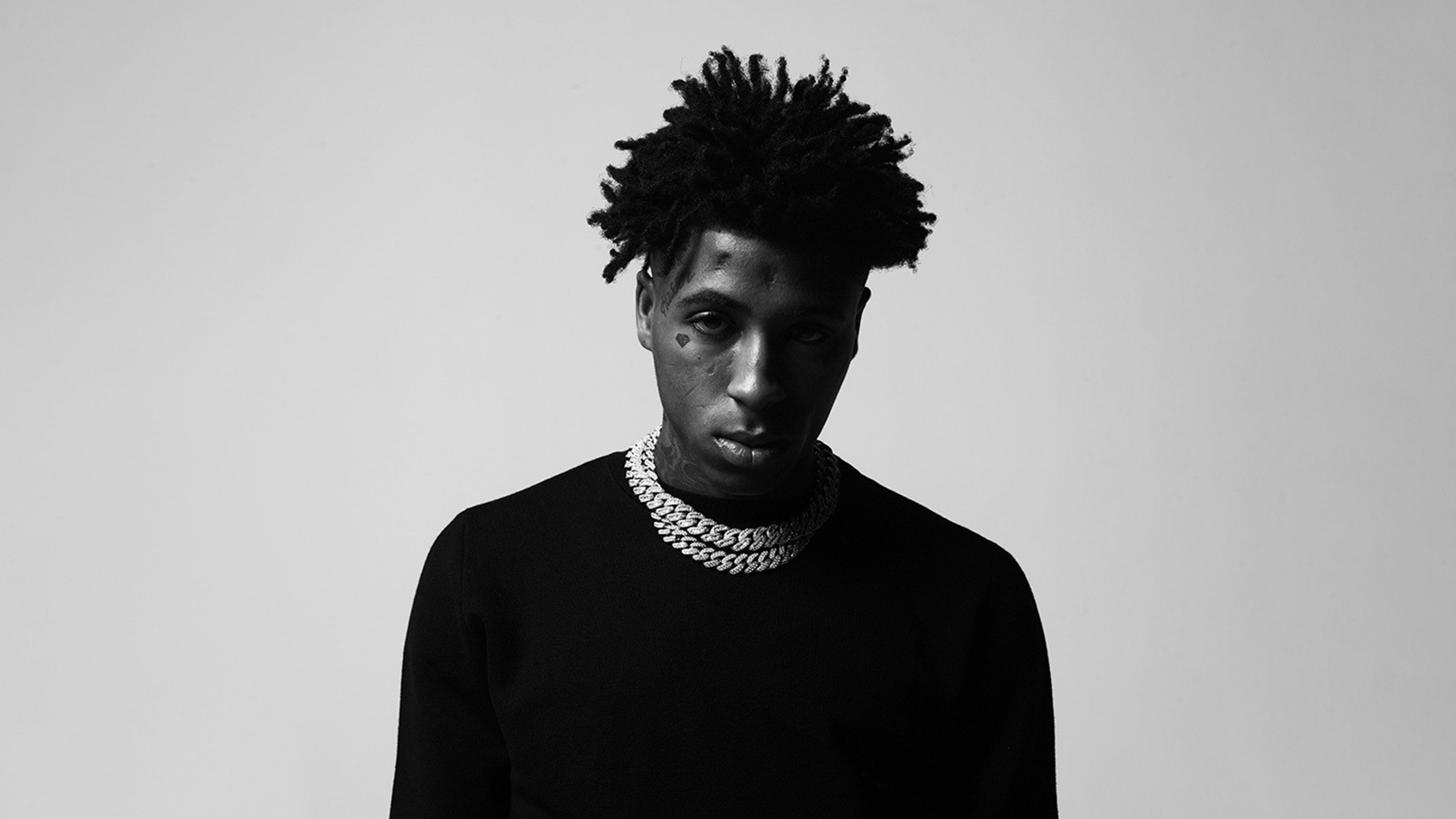 A detailed black and white portrait of American rapper NBA YoungBoy.