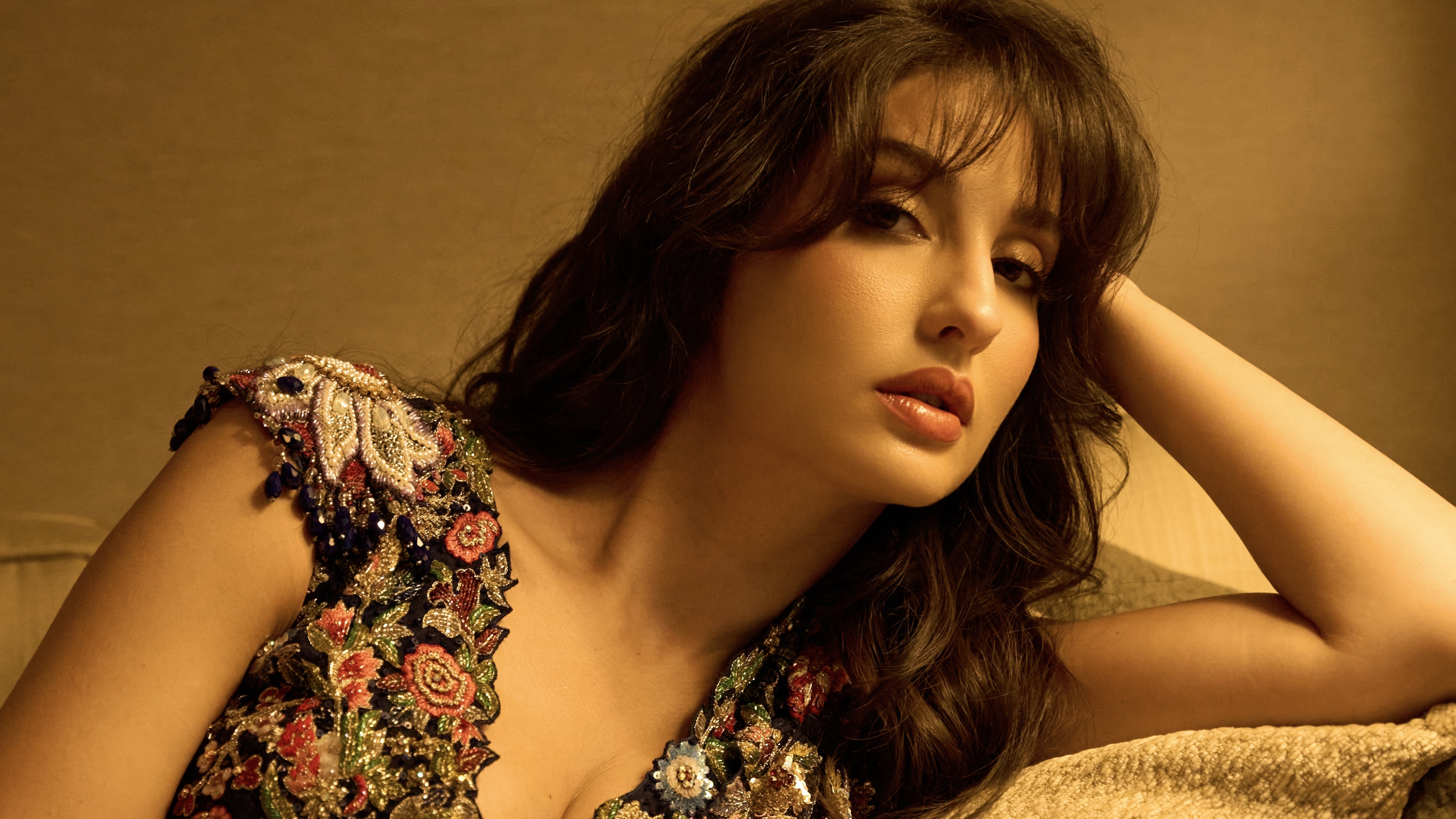 A warm-toned, high-definition portrait of Indian actress Nora Fatehi.