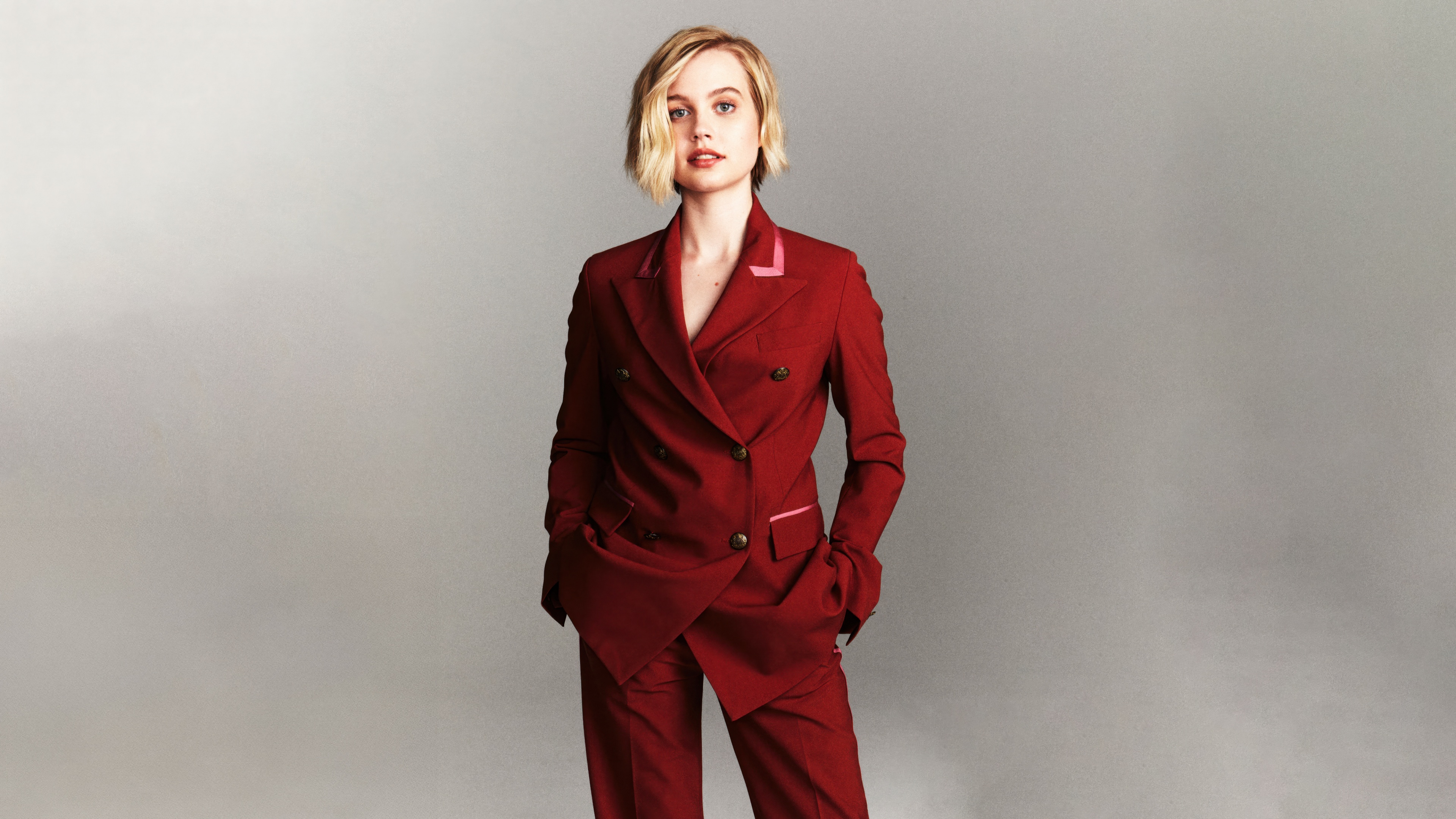 A high-detail portrait of actress Angourie Rice featuring deep burgundy tones.