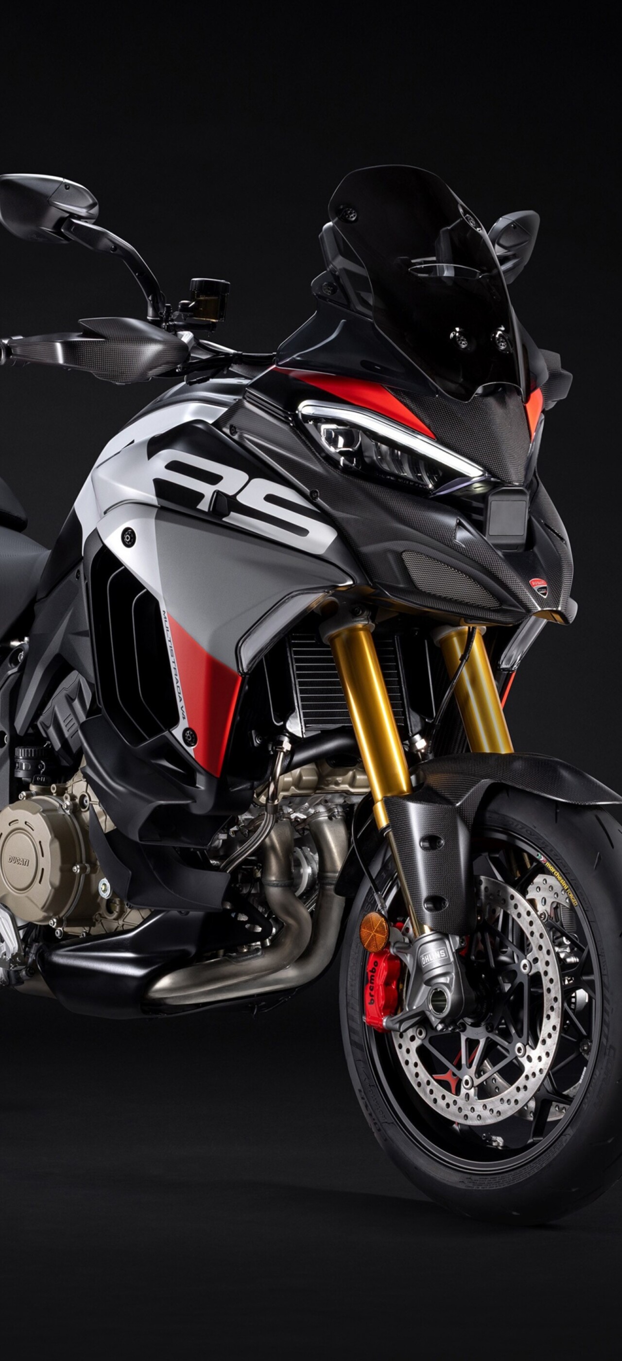 A sleek 2026 Ducati Multistrada V4 RS adventure motorcycle positioned against a dark, moody studio background.