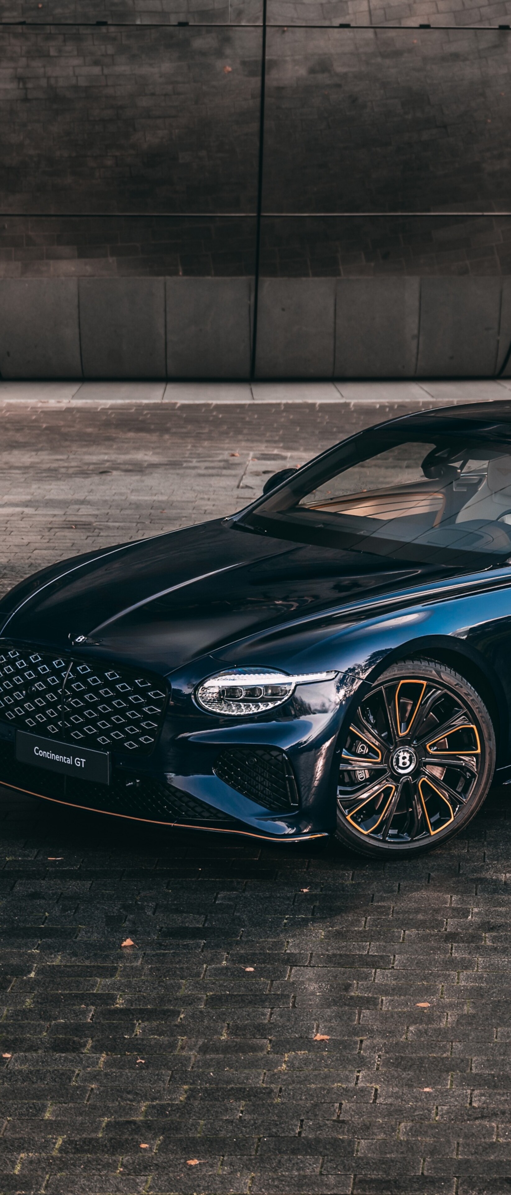 A high-resolution, close-up shot of a luxurious 2025 Bentley Continental GT in a modern setting.