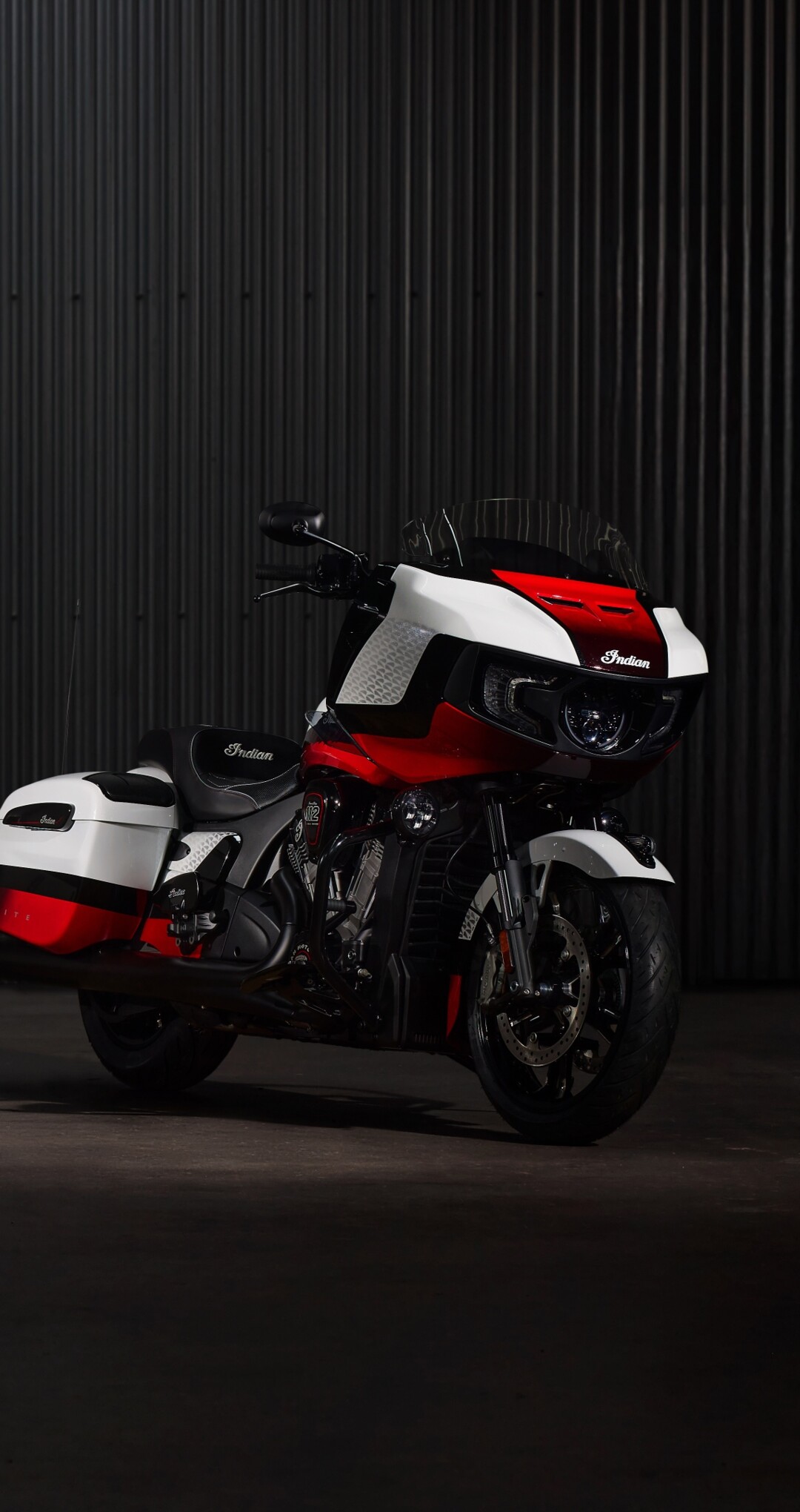 A cinematic close-up of the 2025 Indian Chieftain Elite and Indian Pursuit Elite cruiser motorcycles against a dark, atmospheric background.
