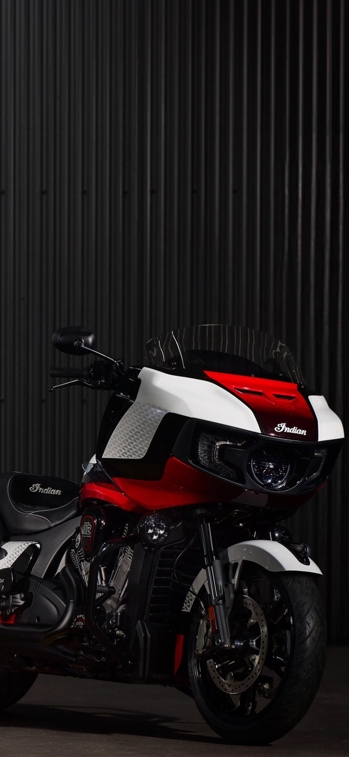 A detailed, cinematic view of the 2025 Indian Chieftain Elite and Indian Pursuit Elite cruiser motorcycles against a dark, moody background.