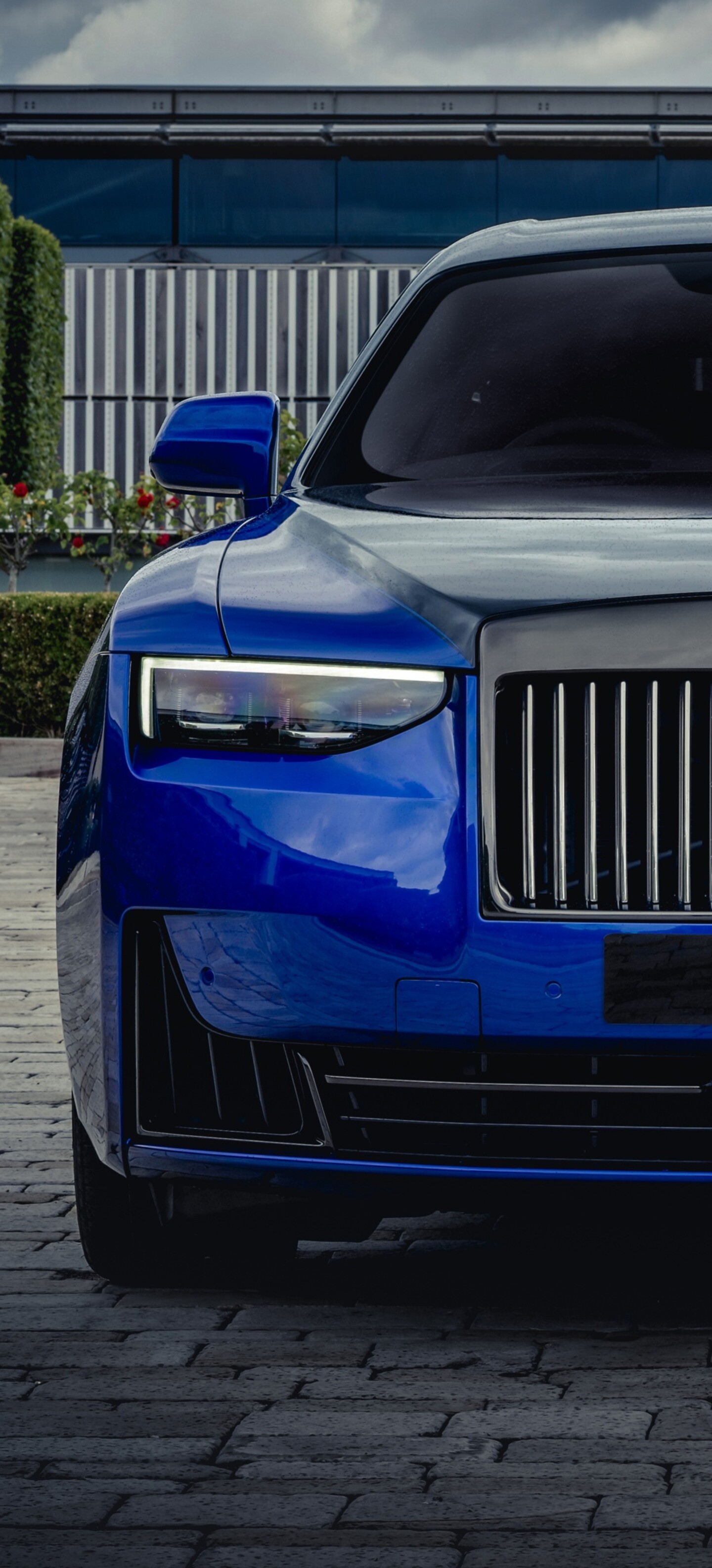 A close-up, high-resolution shot of the 2025 Rolls-Royce Black Badge Ghost featuring a polished dark finish and sophisticated design.