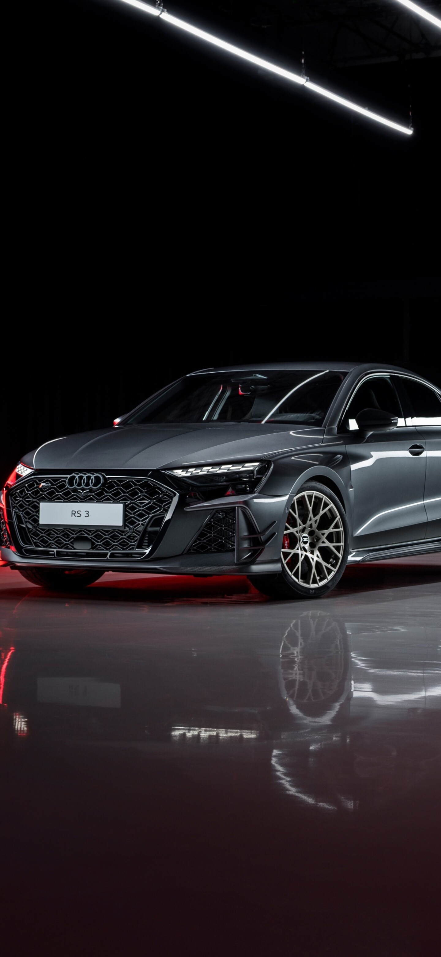 A sleek 2026 Audi RS 3 Sedan with sharp contours and a premium finish, set against a dark, minimalist background.