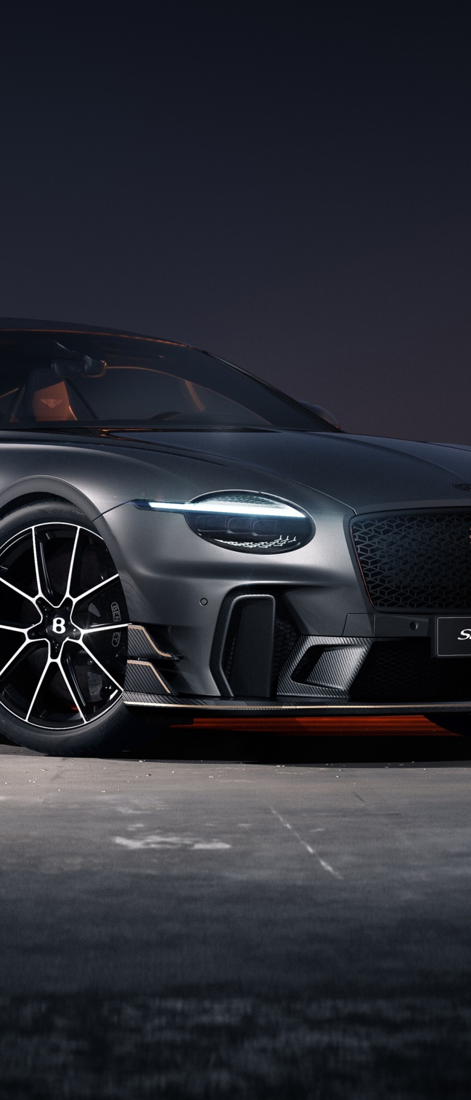 A sleek 2026 Bentley Continental GT Supersports parked in a dark, moody environment with light reflecting off its polished metallic surfaces.