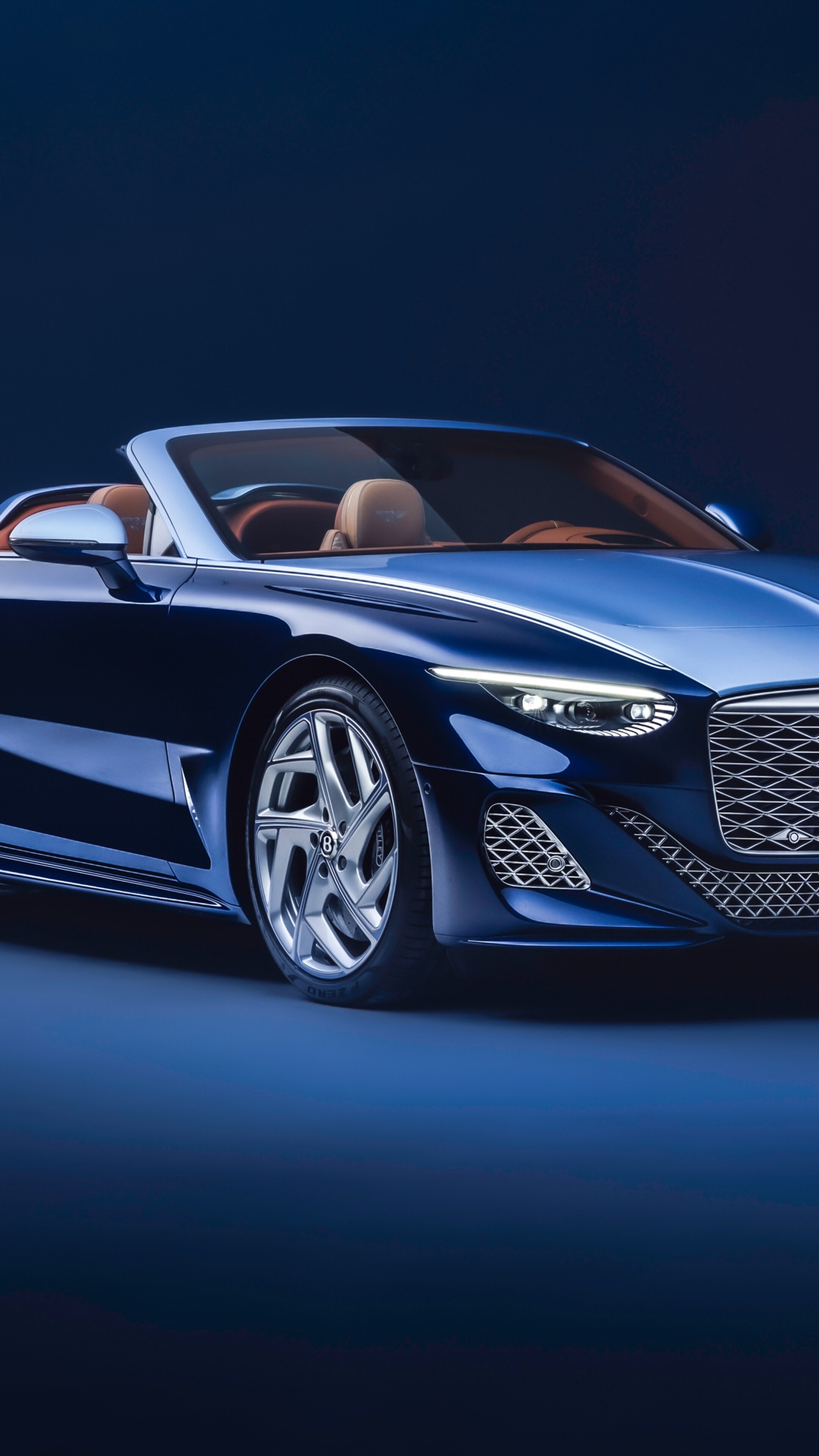 A high-resolution, detailed view of a blue Bentley Mulliner Batur Convertible against a matching blue aesthetic background.
