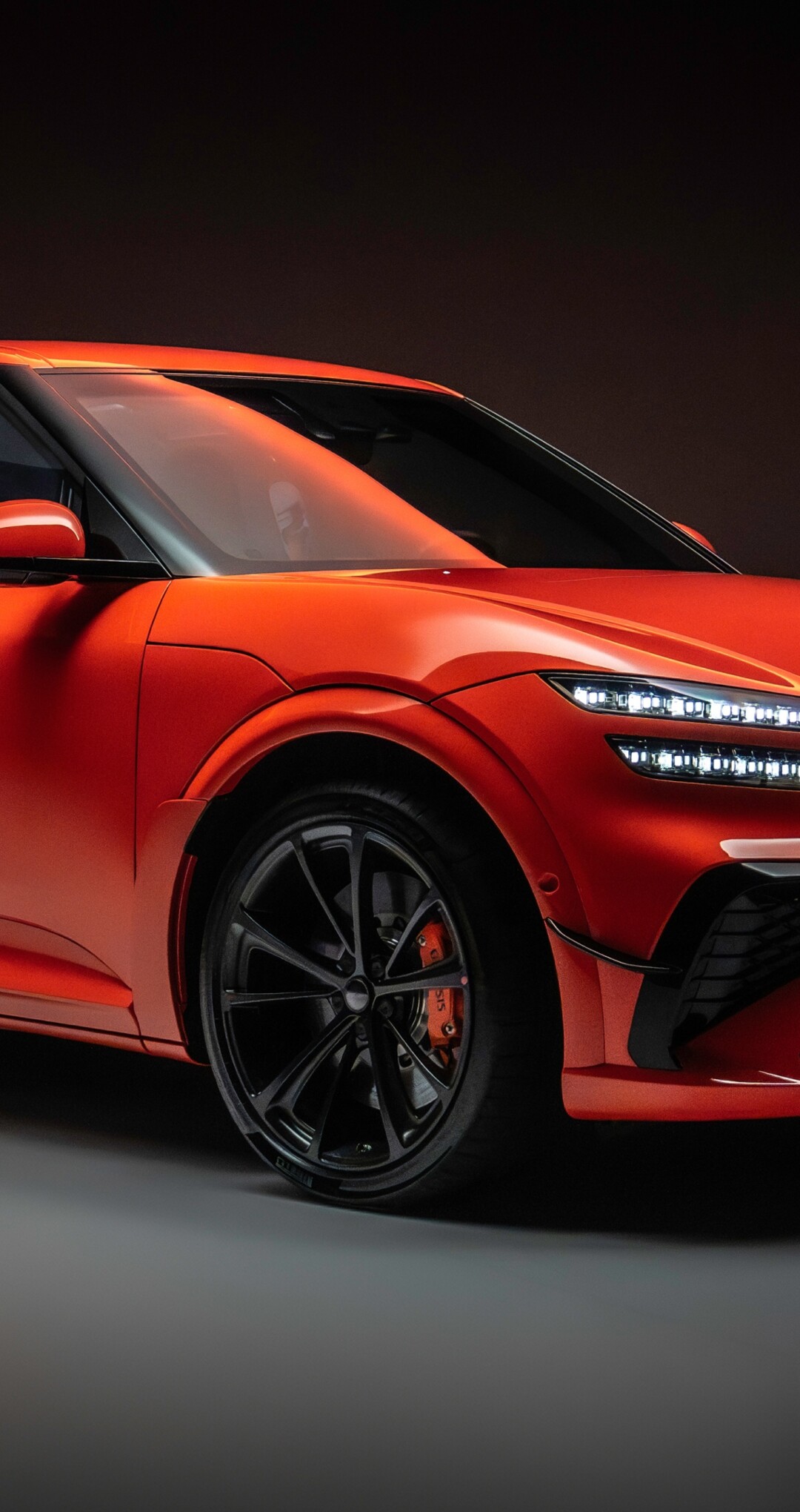 A high-resolution close-up of the sleek and powerful 2026 Genesis GV60 Magma electric crossover.