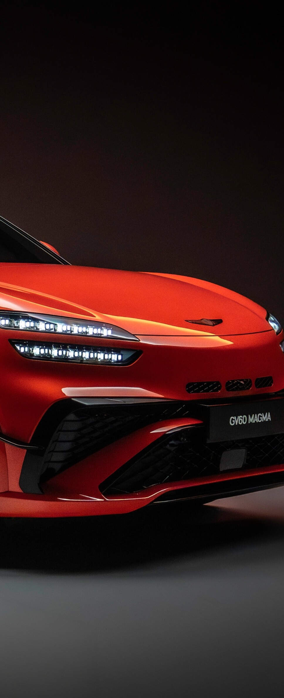 A high-resolution view of the 2026 Genesis GV60 Magma electric crossover featuring a sleek and aggressive design.