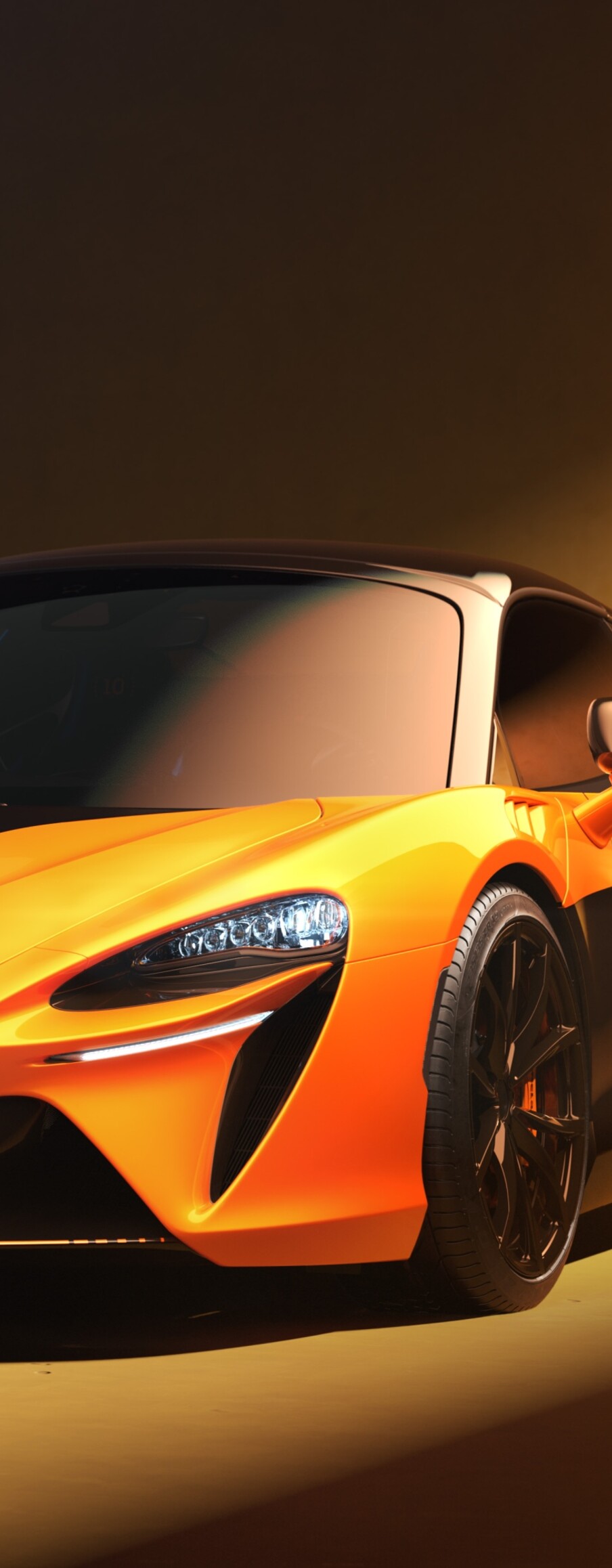 A sleek, bright orange 2026 McLaren Artura Spider Championship Edition sports car captured in high resolution.